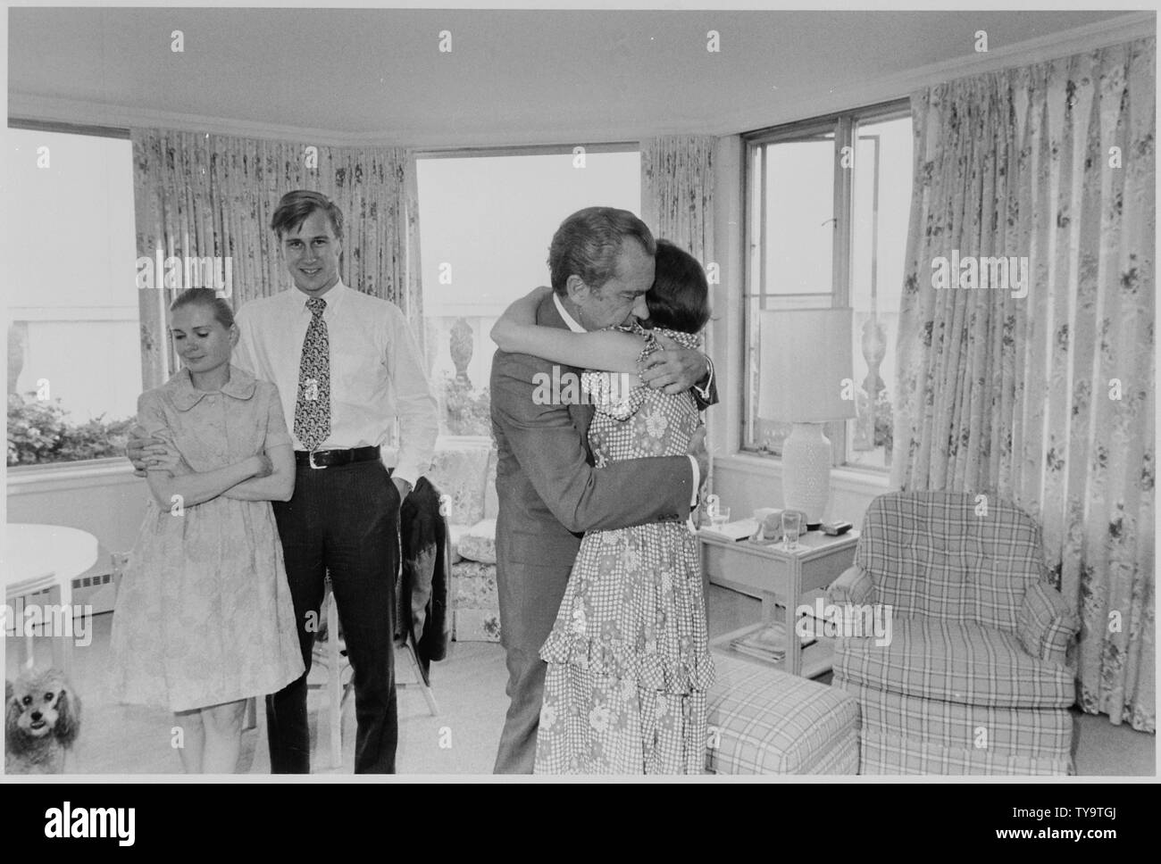 Nixon hugging Julie shortly after his resignation; Scope and content:  Pictured: Tricia Cox, Ed Cox, Richard M. Nixon, Julie Eisenhower. Subject: Last Day. Stock Photo