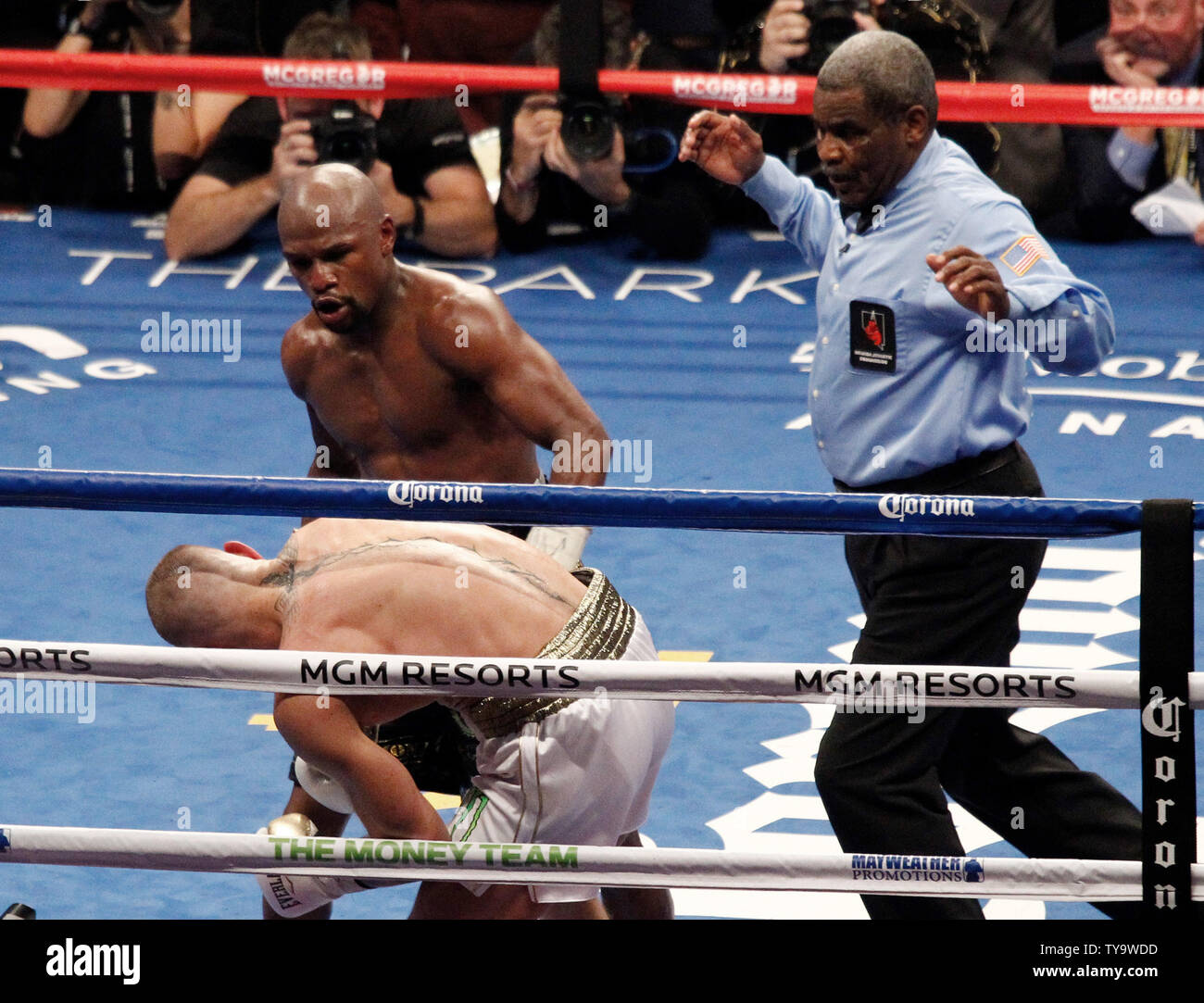 Floyd Mayweather Jr. lands a body shot that stops Conor McGregor in the 10th round during their super-welterweight bout at T-Mobile Arena in Las Vegas, Nevada on August 26, 2017.Photo by James Atoa/UPI Stock Photo