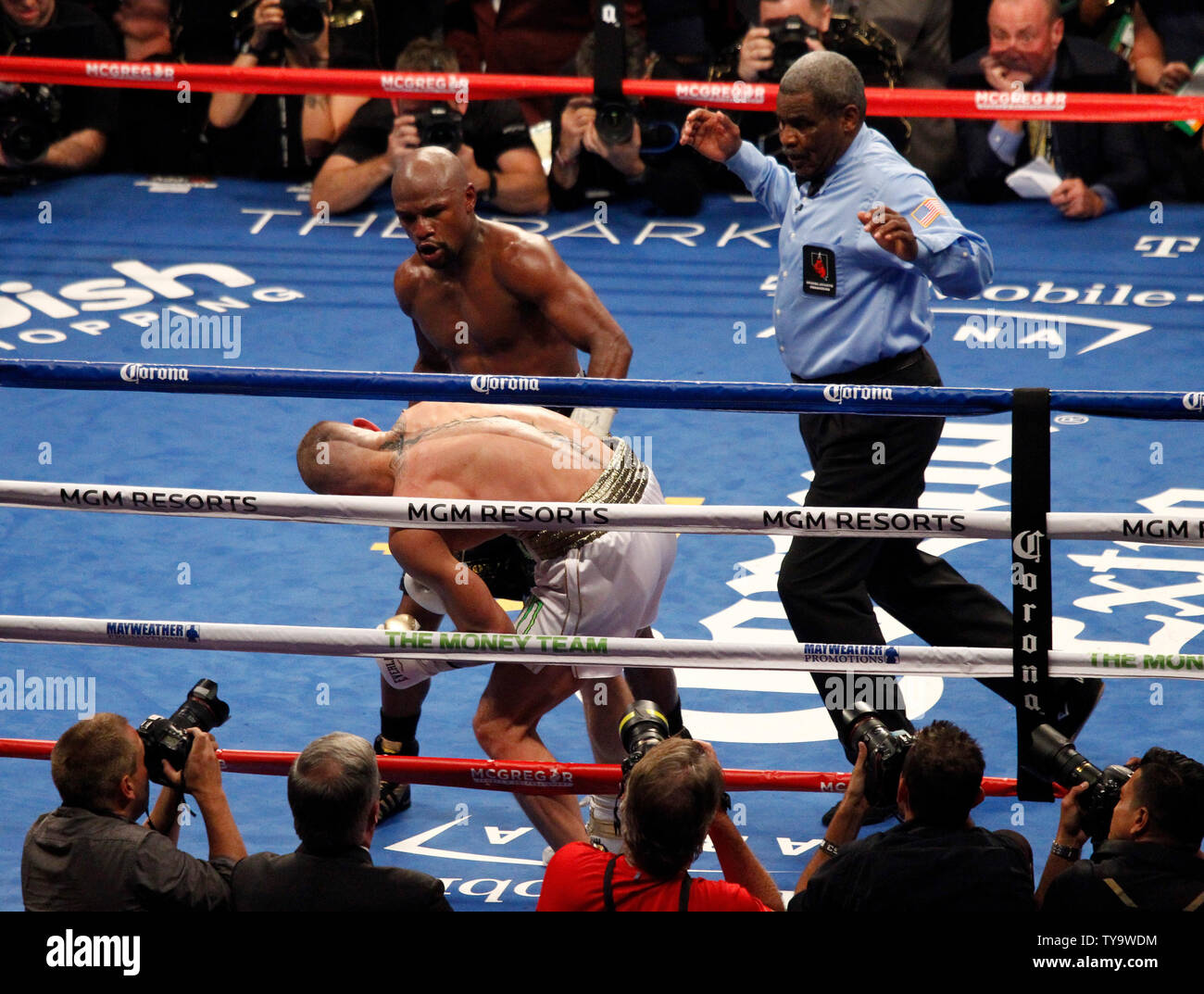 Floyd Mayweather Jr. lands a body shot that stops Conor McGregor in the  10th round during their super-welterweight bout at T-Mobile Arena in Las  Vegas, Nevada on August 26, 2017.Photo by James