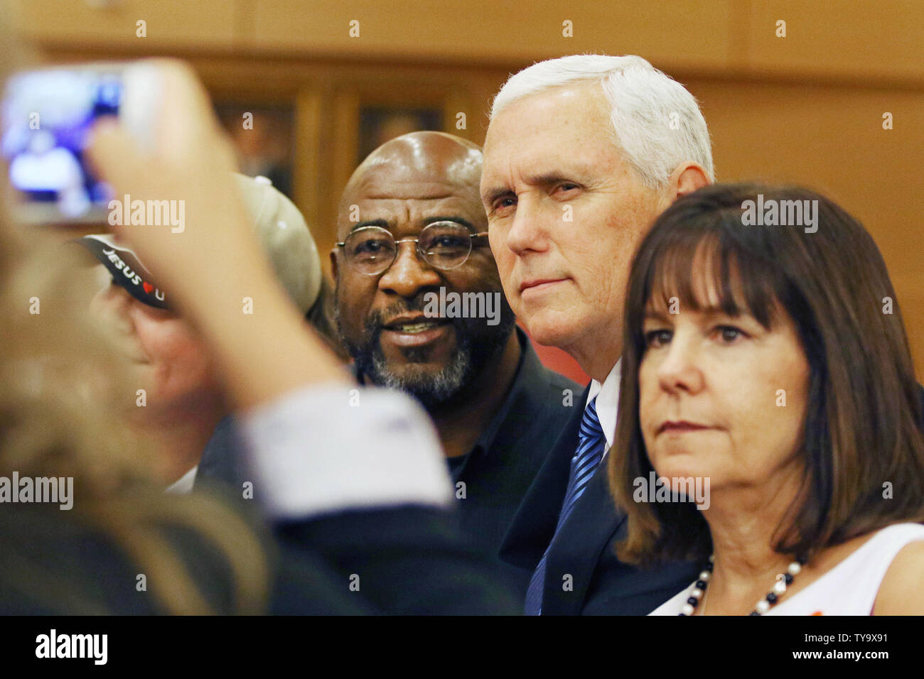 Vice President Mike Pence, second from right, with wife Karen Pence, pose for a personal photo with Phillip Washington after speaking at Las Vegas City Hall October 7, 2017, in Las Vegas. Pence spoke after a community prayer walk concluded for the victims of the October 1, 2017, Las Vegas massacre. Photo by Ronda Churchill/UPI Stock Photo