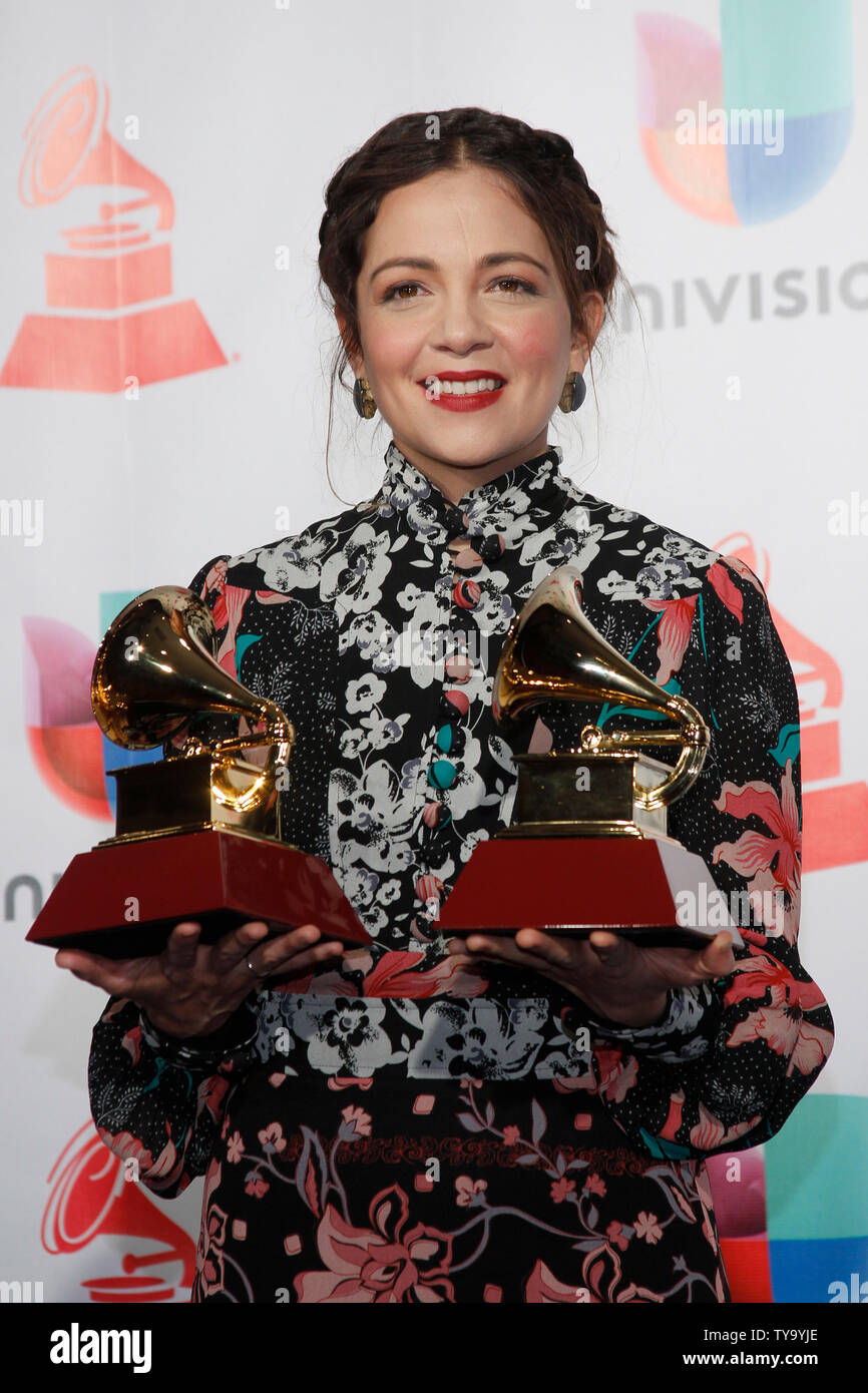 Natalia Lafourcade appears backstage with the awards for best folk