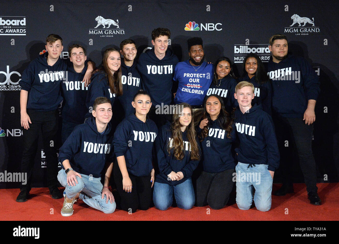 Shawn Mendes (center left) and Khalid (center right) appear backstage