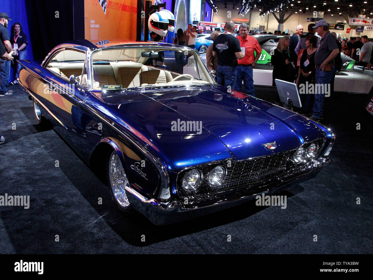 Attendees stop for a view of a customzied 1960 Ford Starliner on display during the 2018 SEMA Show, at the Las Vegas Convention center in Las Vegas, Nevada, October 30, 2018. Photo by James Atoa/UPI Stock Photo