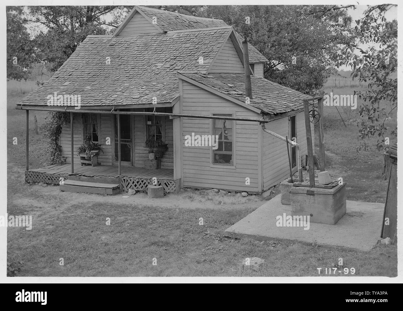 Old clapboard house with well next to it. Newton County; Scope and