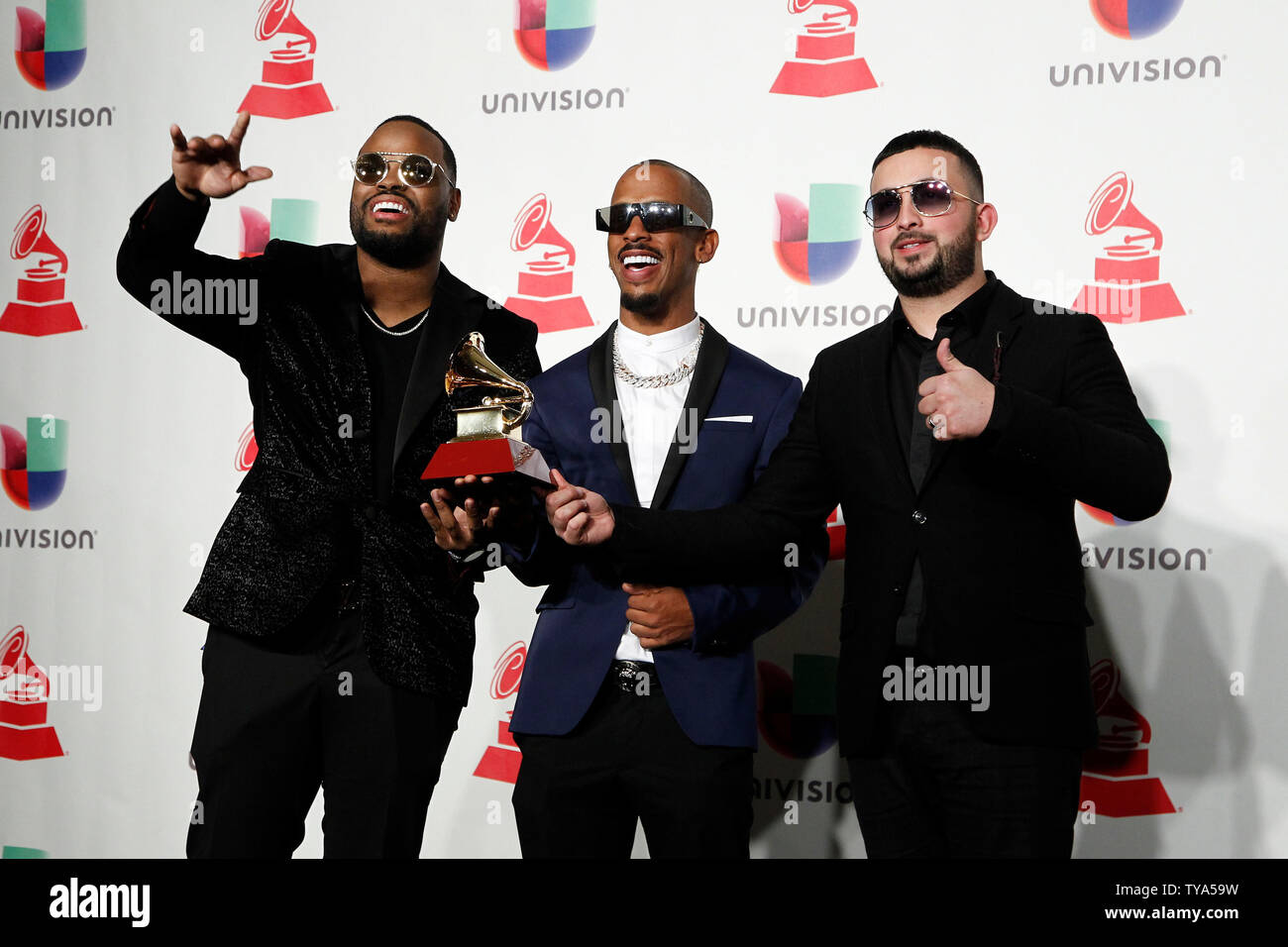 Luis 'Rome' Romero (L), DJ Urba and Juan Rivera 'Gaby Music' Vazquez  appear backstage with the award for best urban album for 'Dura' during the 19th annual Latin Grammy Awards at the MGM Garden Arena in Las Vegas, Nevada on November 15, 2018. Photo by James Atoa/UPI Stock Photo