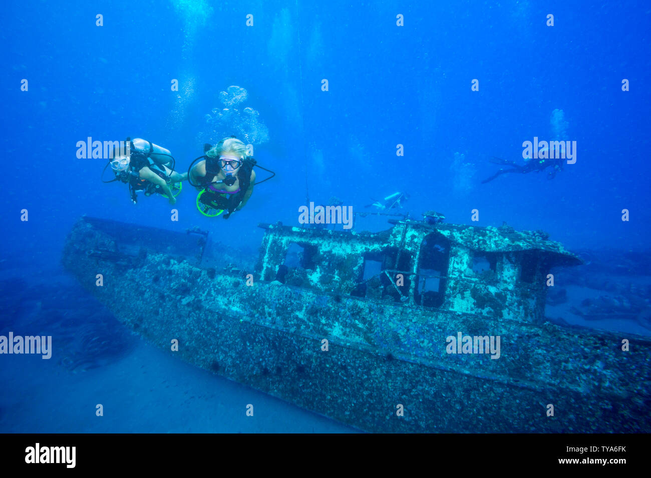Two female divers (MR) on underwater scooters on the wreck of the Saint
