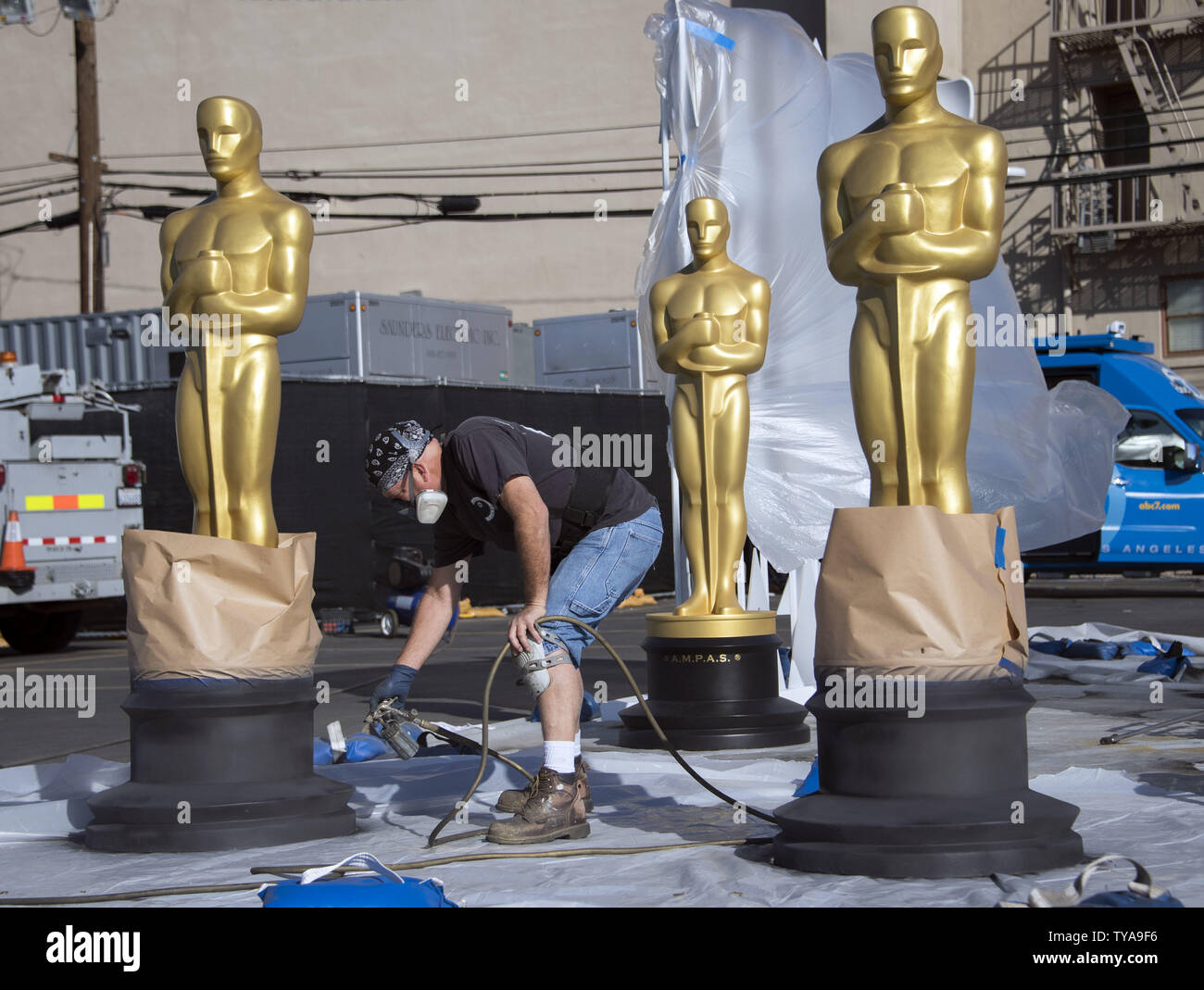A worker paints a Oscar statue as preparations are underway for the 89th annual Academy Awards in the Hollywood section of Los Angeles on February 24, 2017. The 2017 Academy Awards will take place this Sunday, February 25. Photo by Kevin Dietsch/UPI Stock Photo