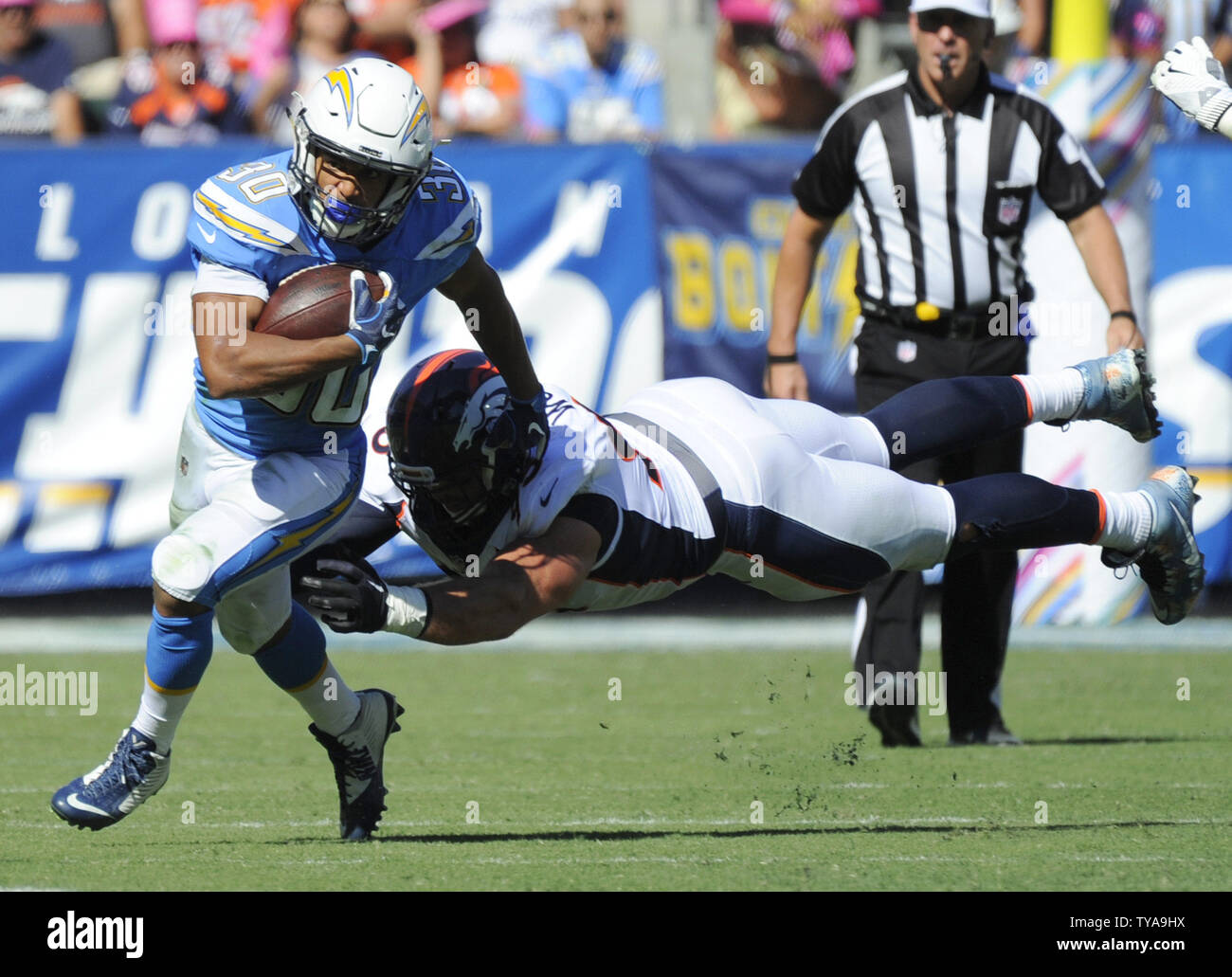 Carson, CA. 18th Nov, 2018. Los Angeles Chargers running back Austin Ekeler  #30 after a catch straight arming Denver Broncos inside linebacker Josey  Jewell #47 during the NFL Denver Broncos vs Los