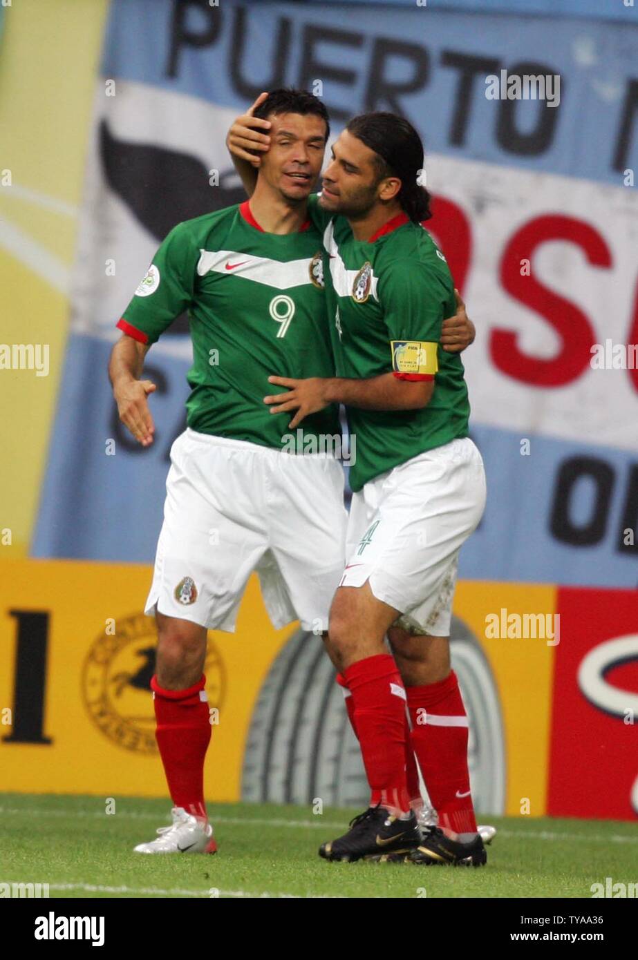 Mexico's Jared Borgetti congratulates teammate Rafael Marquez after he scored the first goal during the 16 knock-out stage of the FIFA World Cup Germany 2006 at the Zentralstadion in Leipzig, Germany, on June 24, 2006. Argentina needed extra-time and a wonder strike from Maxi Rodriguez to give them a 2-1 victory over Mexico and a place in the quarter-finals.   (UPI Photo/Christian Brunskill) Stock Photo