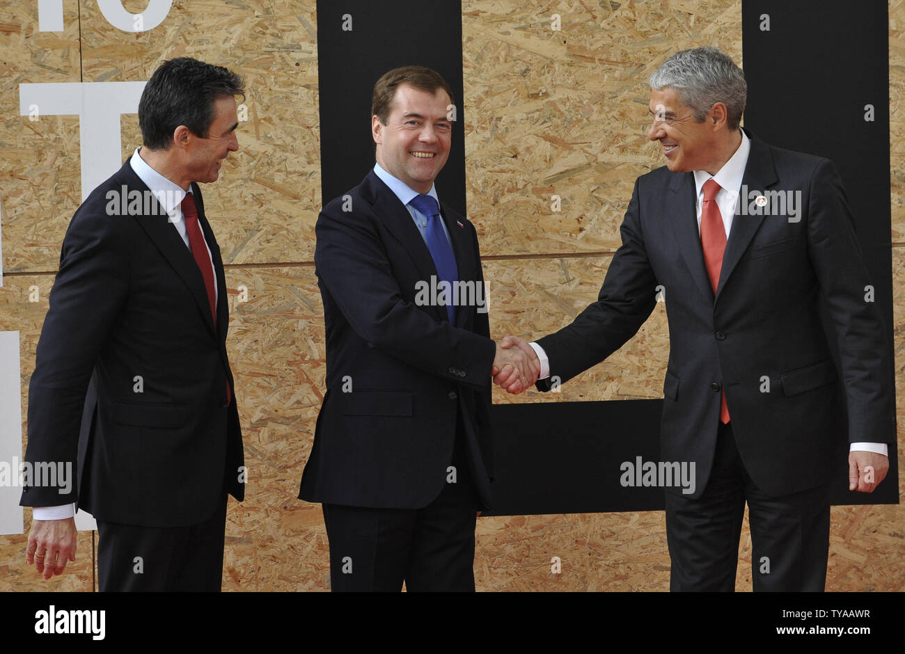 NATO Secretary General Anders Fogh (L) looks on as Russian President Dmitry Medvedev (C) shkaes hands with Portugal's Prime Minister Jose Socrates  before NATO Russia Council meeting during  NATO summit in Lisbon on November 20, 2010.. UPI Stock Photo