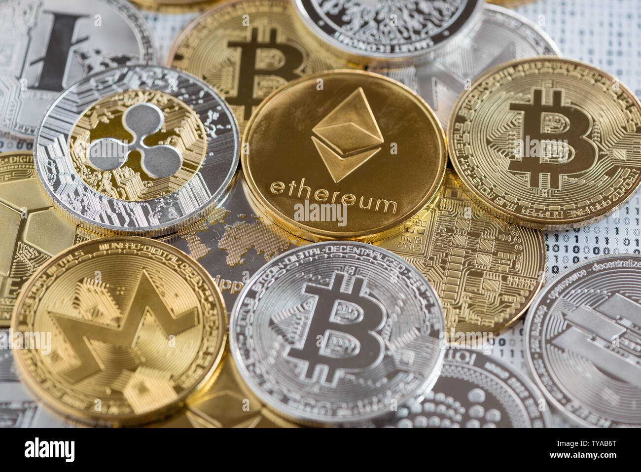 Detail of Crypto currency coins - Bitcoin, Litecoin, Dash, Ethereum,  Monero, IOATA, Ripple, NEO on binary 1 and 0 background Stock Photo - Alamy