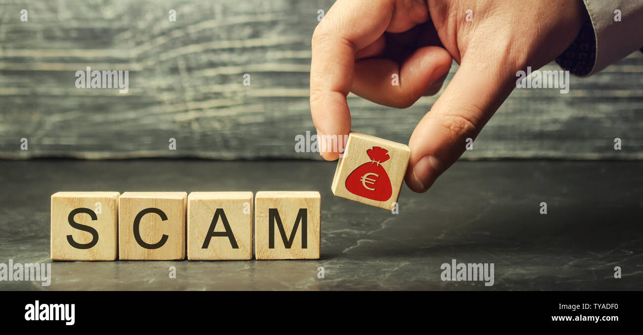 Businessman puts wooden blocks with the word Scam. Fraudulent