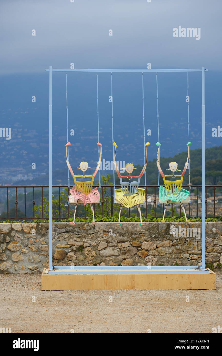 Mougins, France - April 03, 2019: Art installation Three girls on swings Stock Photo