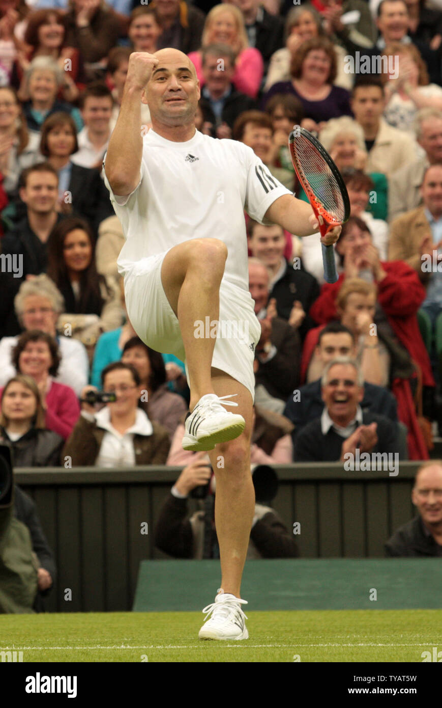 American tennis star Andre Agassi celebrates a point during a mixed doubles match with his wife Steffi Graf against Britain Tim Henman and Kim Clijsters. The match was played to celebrate the first game on the new Wimbledon Center court with the roof fully closed on Sunday May 17 2009. (UPI Photo/Hugo Philpott) Stock Photo