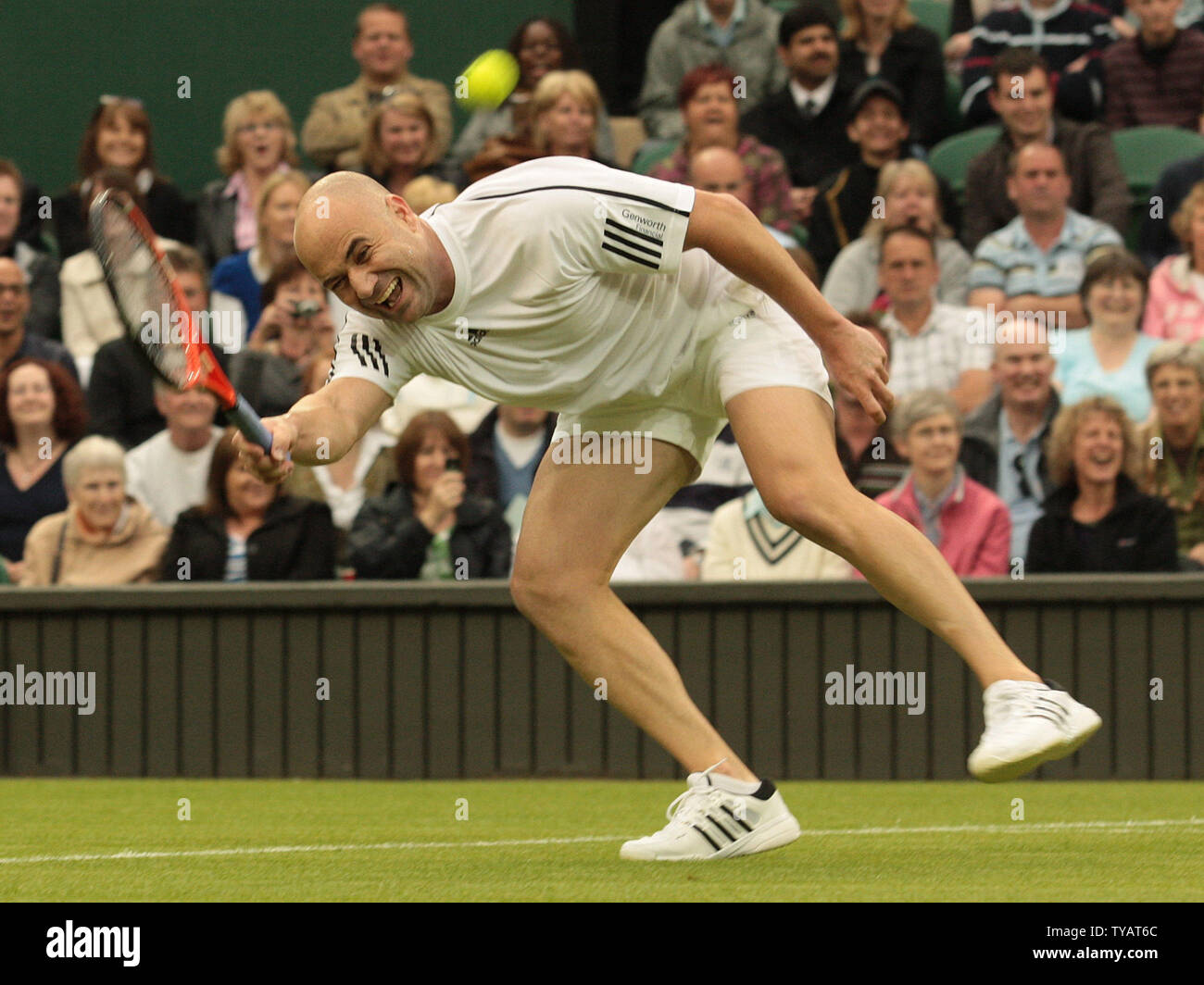 American tennis star Andre Agassi returns a ball during a mixed doubles match with wife Steffi Graf against Britain Tim Henman and Kim Clijsters. The match was played to celebrate the first game on the new Wimbledon centre court with the roof fully closed on Sunday May 17 2009. (UPi Photo/Hugo Philpott) Stock Photo
