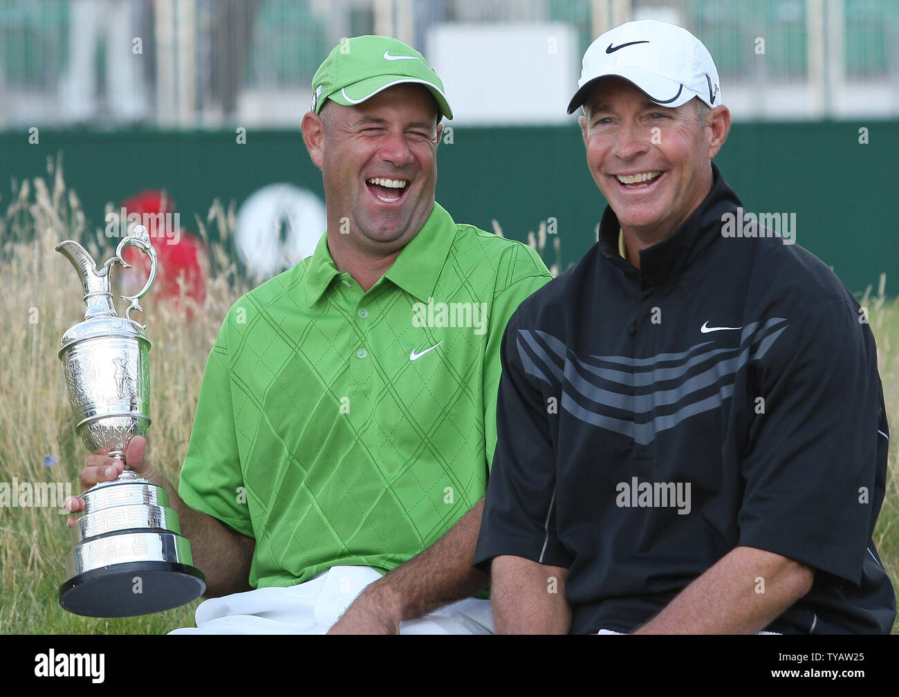 American Stewart Cink (L) holds the claret jug as he laughs with his  caddie, Frank Williams, after defeating Tom Watson in a four hole play off  on the fourth day of the