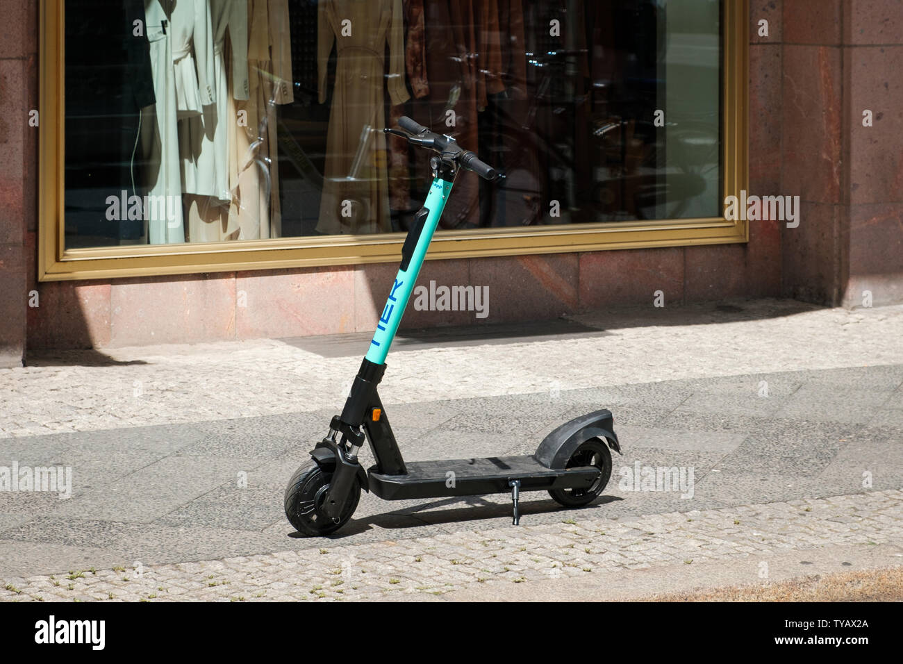 Berlin, Germany - June, 2019: Electric scooter , escooter or e-scooter of the ride sharing company TIER on sidewalk in Berlin, Germany Stock Photo