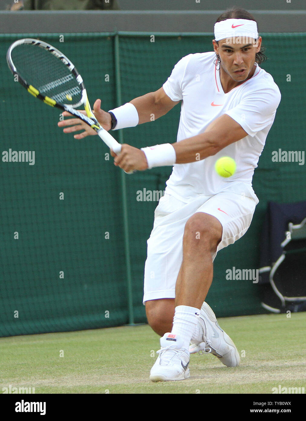 Sapain's Rafael Nadal plays a backhand in his match with Frenchman Paul-Henri Mathieu on the seventh day of the Wimbledon championships in Wimbledon on June 28, 2010.    UPI/Hugo Philpott Stock Photo