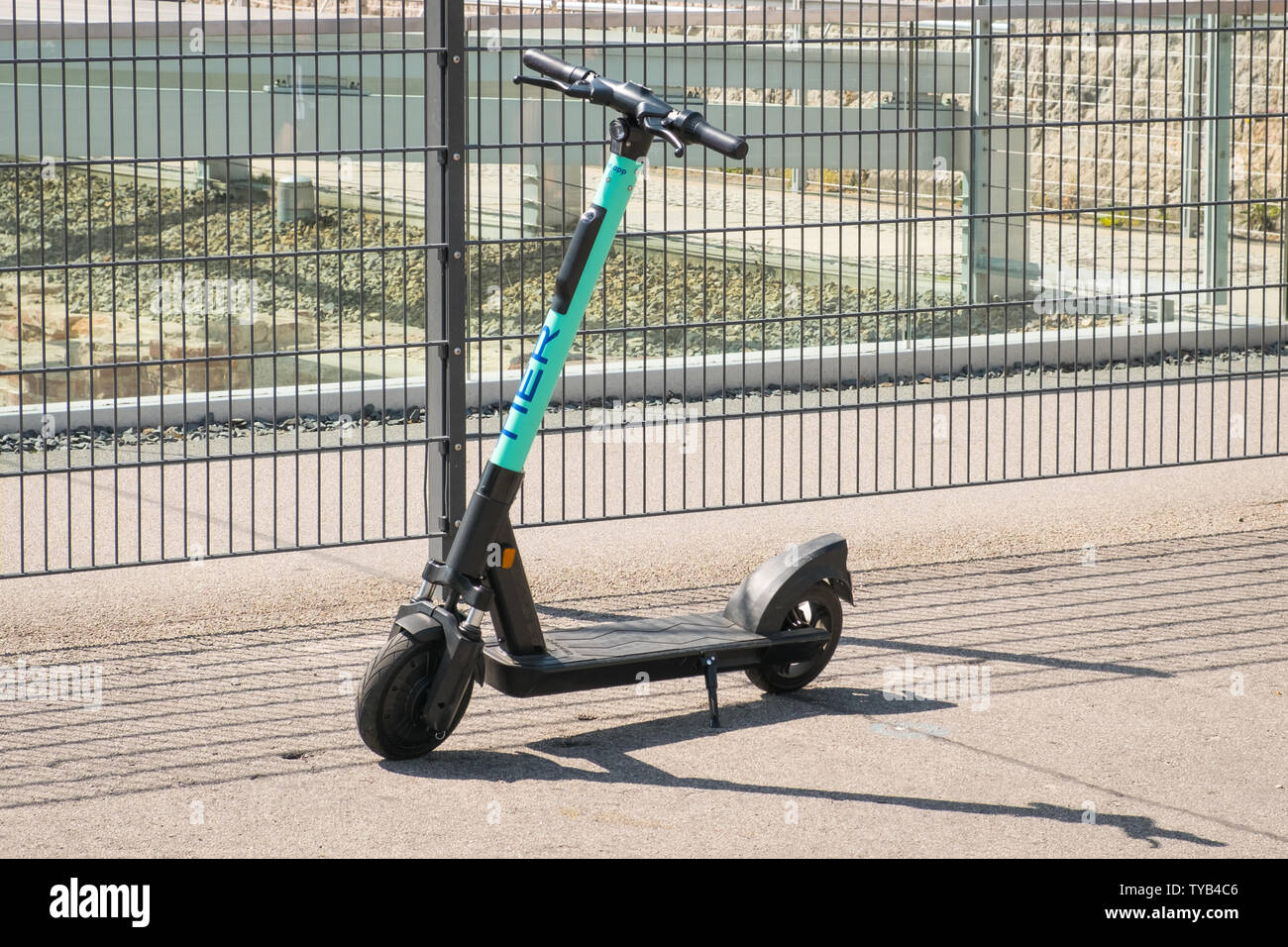 Berlin, Germany - June, 2019: Electric scooter , escooter or e-scooter of the ride sharing company TIER on sidewalk in Berlin, Germany Stock Photo