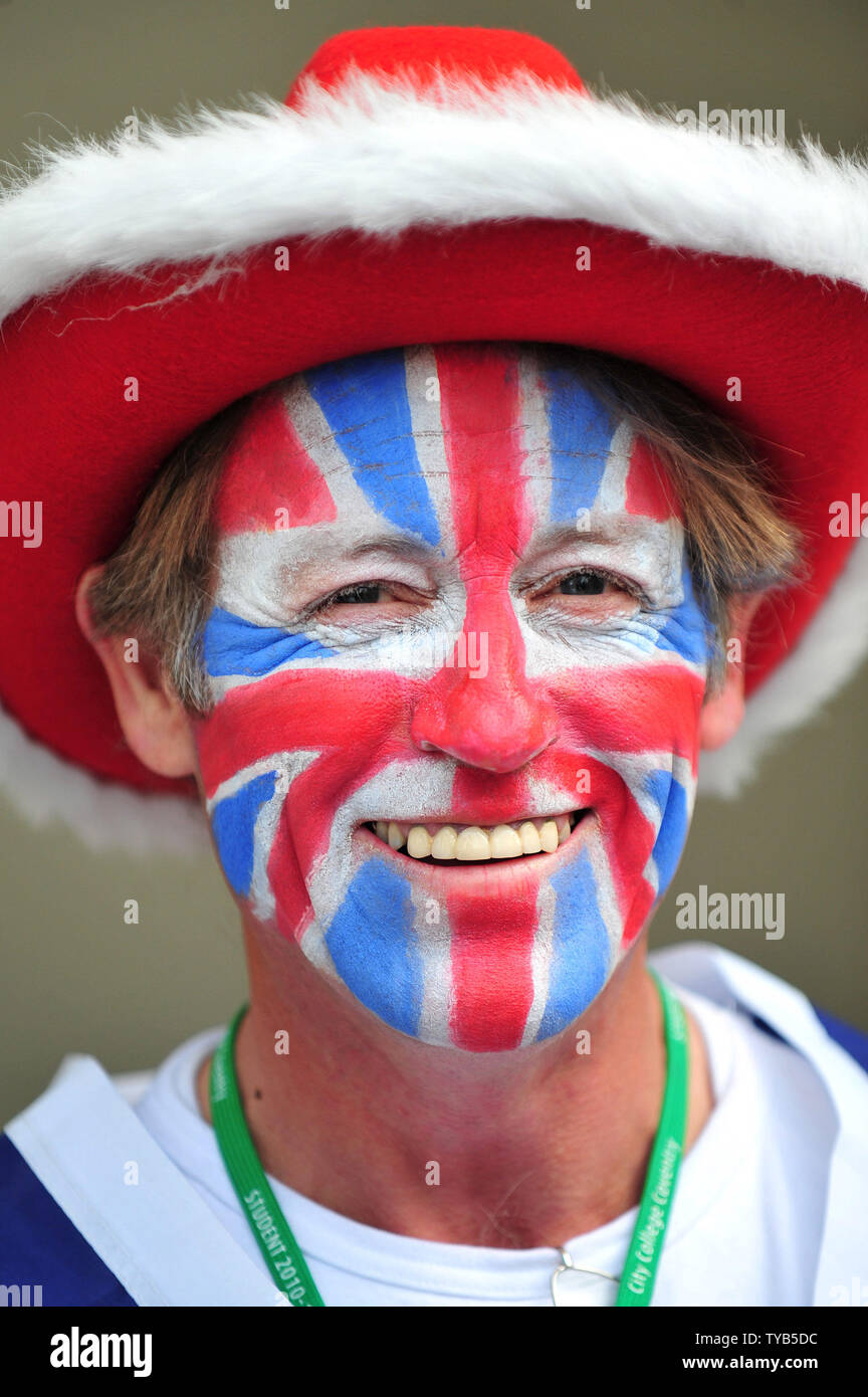 A Royal enthusiast with a Union Jack painted on his face walks through the crowd in front of Westminster Abby as final preparations are being made for the Royal wedding between Prince William and Kate Middleton, in London, April 28, 2011.  The Royal Wedding will take place on April 29th. UPI/Kevin Dietsch Stock Photo