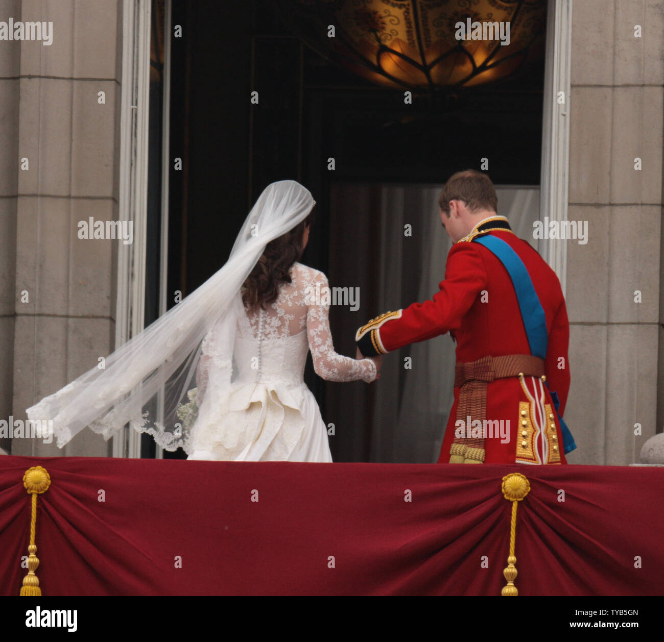 Prince William and Princess Catherine turn to go inside Buckingham Palace after their wedding at Westminster Abbey on April 29, 2011 The Royal couple will now be known as the Duke and Duchess of Cambridge.    UPI /HugoPhilpott Stock Photo