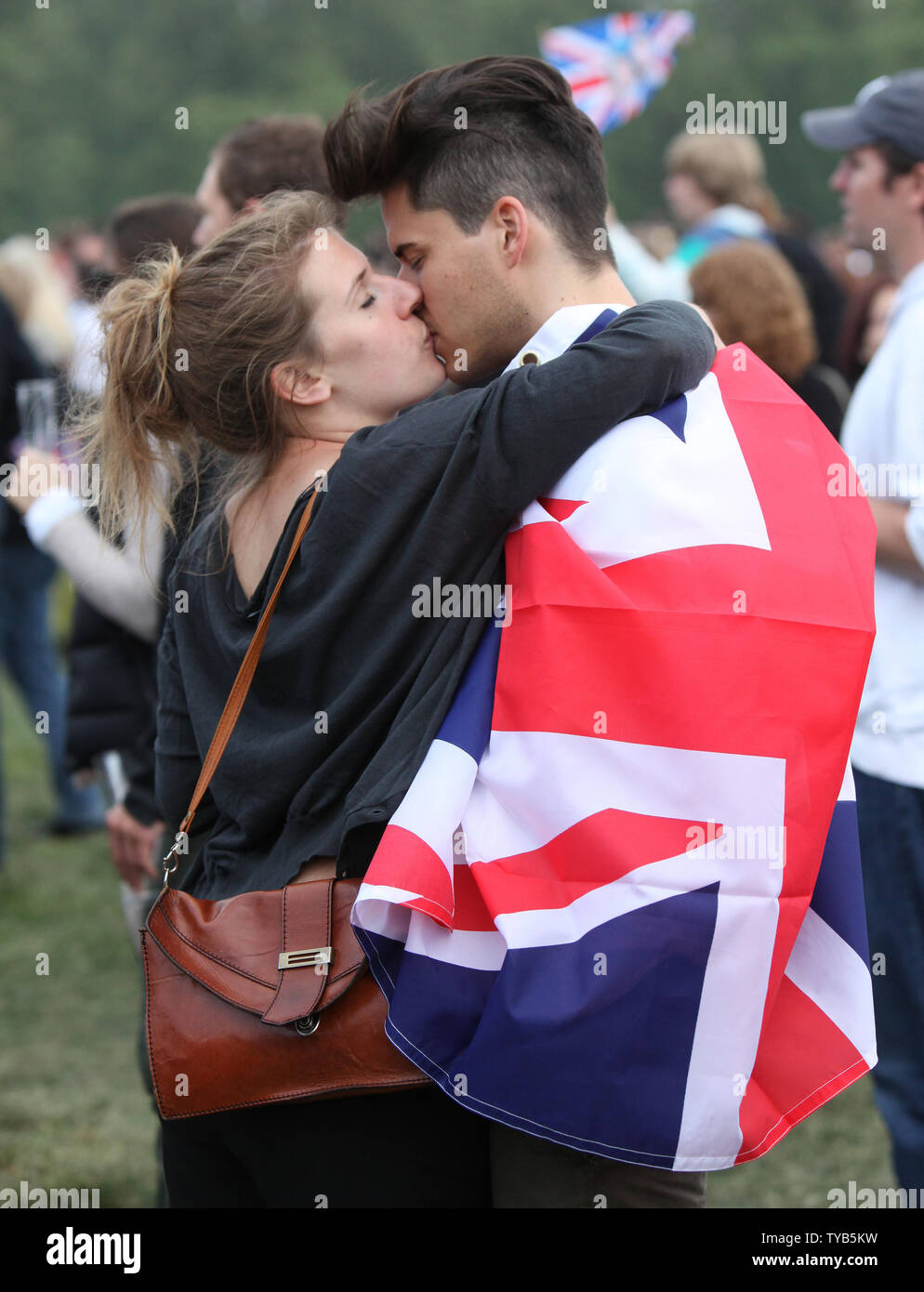 Royal well-wishers share a kiss during the celebration the wedding of Prince  William and Princess Catherine in Hyde Park in London on April 29, 2011.  The former Kate Middleton married Prince William