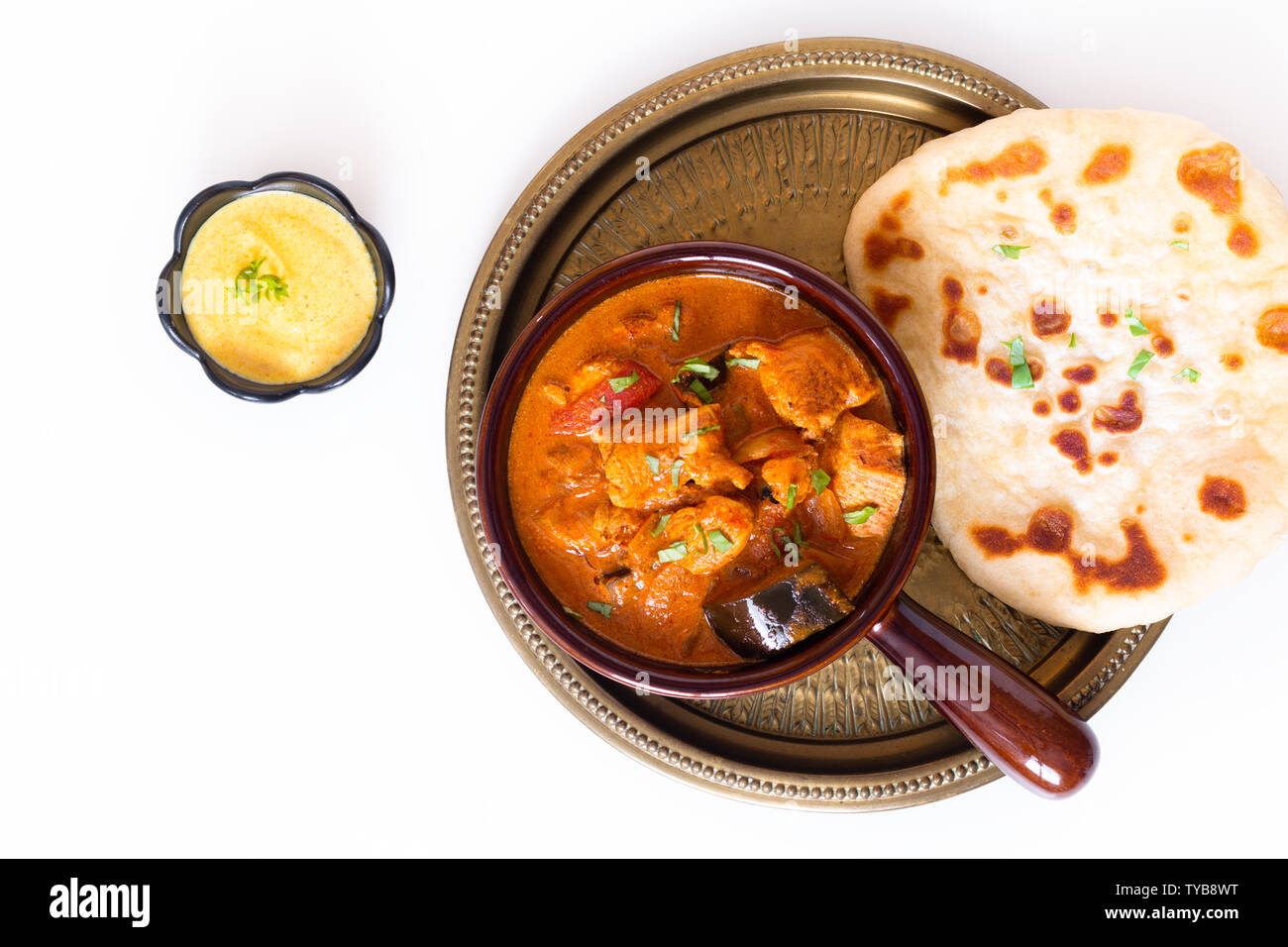 Food concept homemade Tandoori Chicken Masala curry with naan bread and yogurt dipping sauce