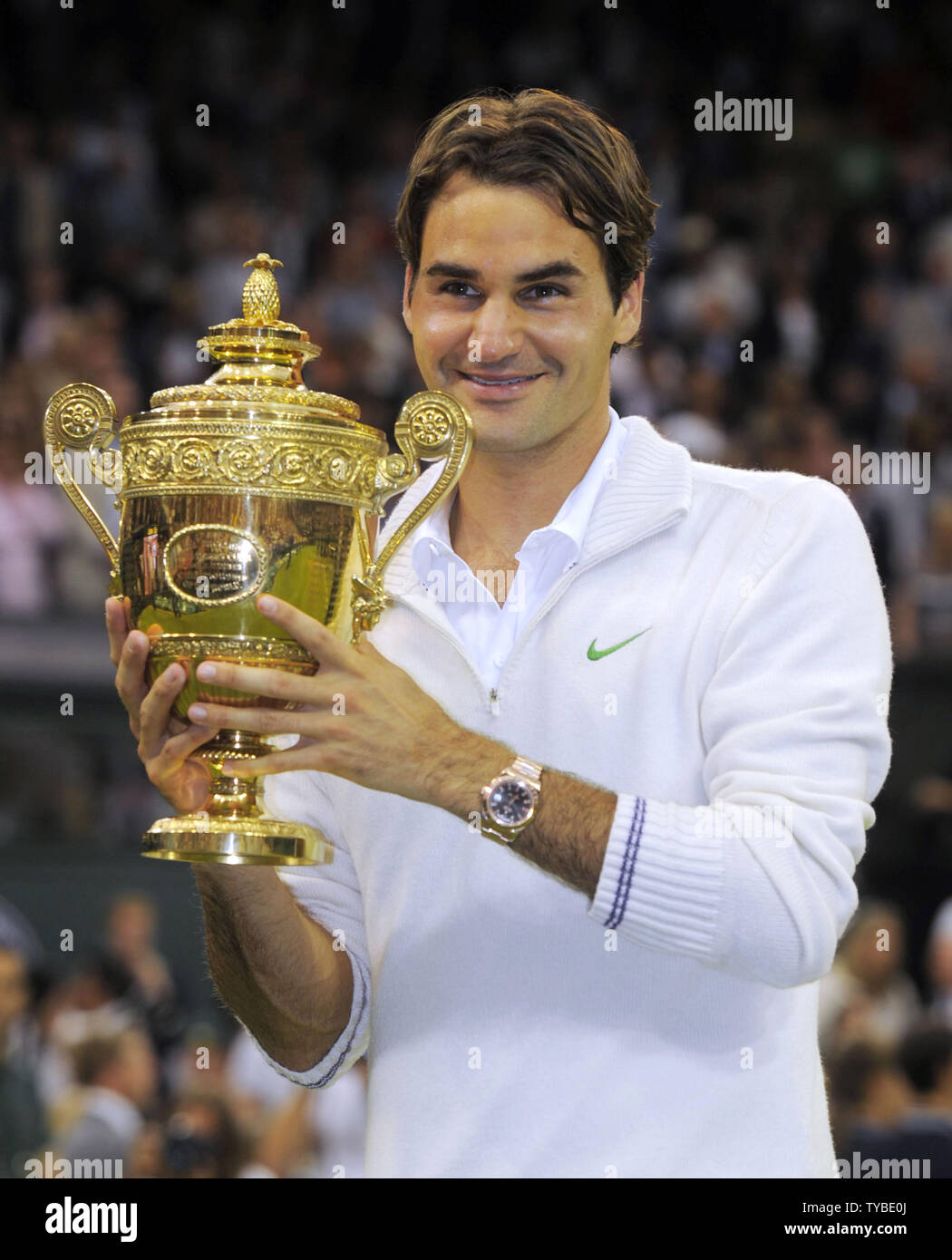 Switzerland's Roger Federer holds the Wimbledon trophy after his win in the  Men's Singles Final against Britain's Andy Murray on the thirteenth day of  the 2012 Wimbledon championships in London, July 8,