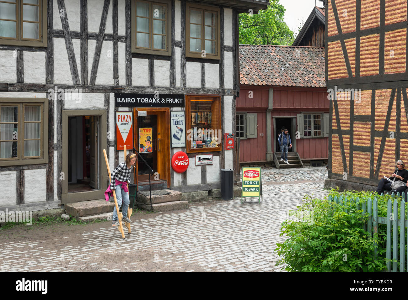 Norsk Folkemuseum, view of a girl walking on stilts in a recreated 19th ...