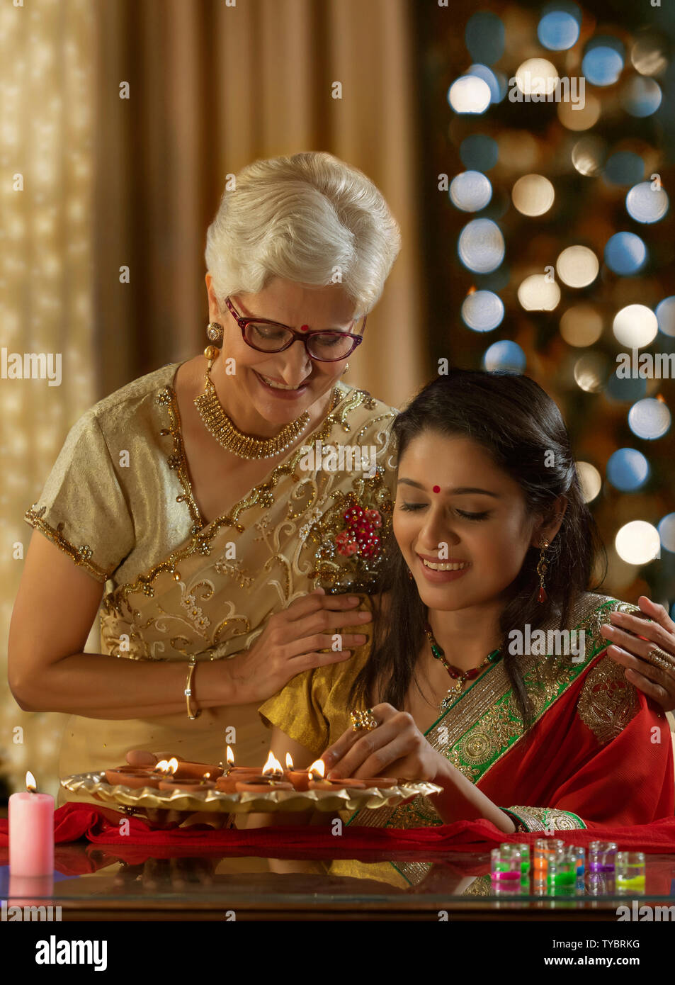 Daughter in law decorating the house with mother in law on the occasion of diwali Stock Photo