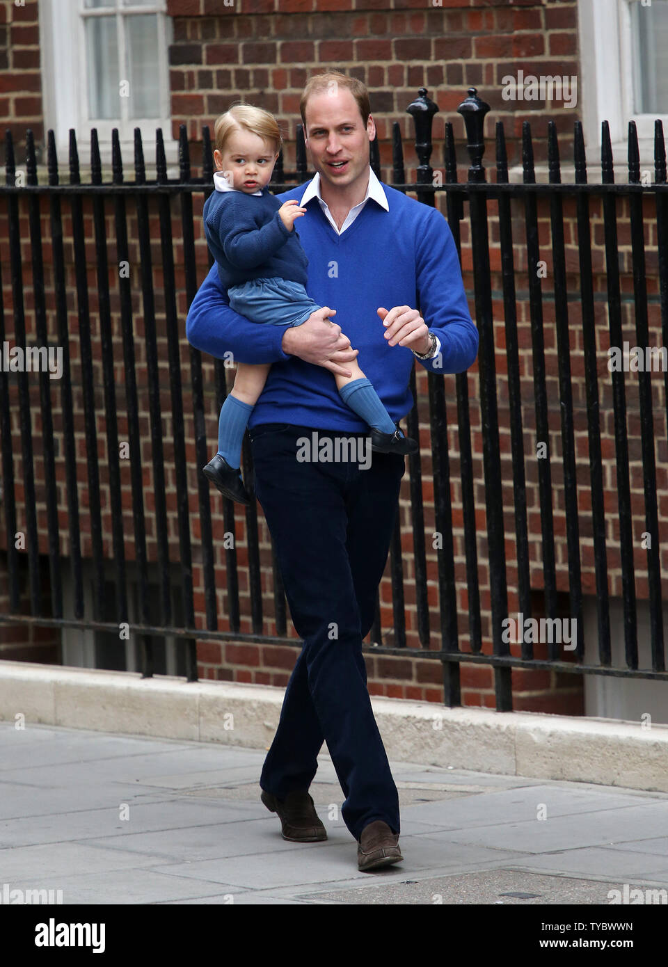 His Royal Highness Prince William carries Prince George to see the new Royal baby at the Lindo Wing St Mary's Hospital, London on May 02, 2015. The Duchess of Cornwall gave birth to a girl weighing eight ponds three ounces.  Photo by Hugo Philpott/UPI. Stock Photo