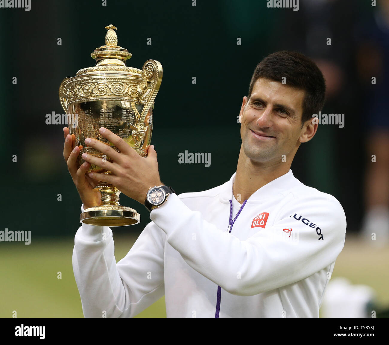 Serbian Novak Djokovic holds the trophy after winning the 2015 Wimbledon  Men's Singles Final against Swiss