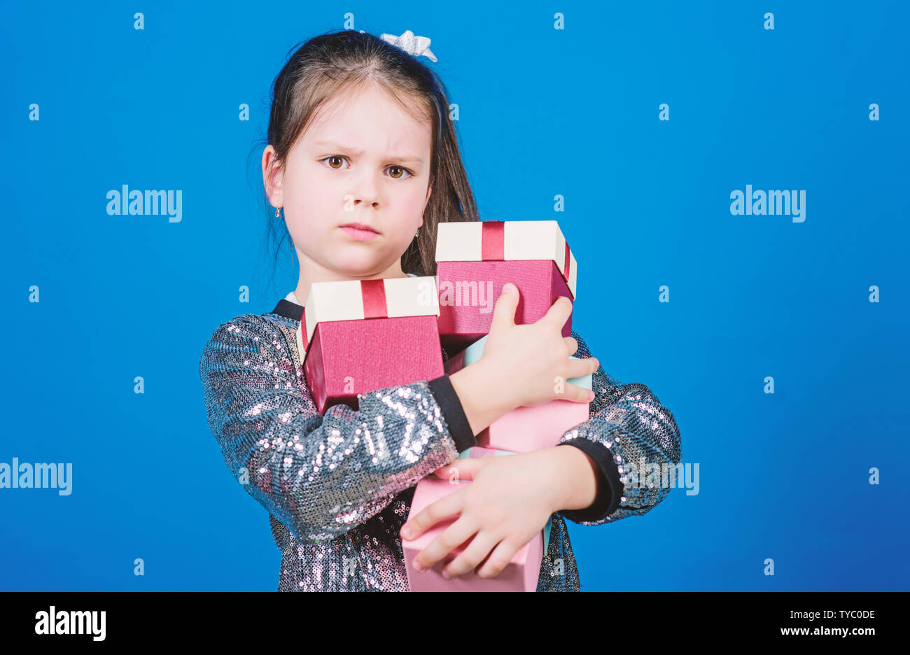 Only for me. Special happens every day. Girl with gift boxes blue background. Black friday. Shopping day. Child carry lot gift boxes. Surprise gift box. Birthday wish list. World of happiness. Stock Photo