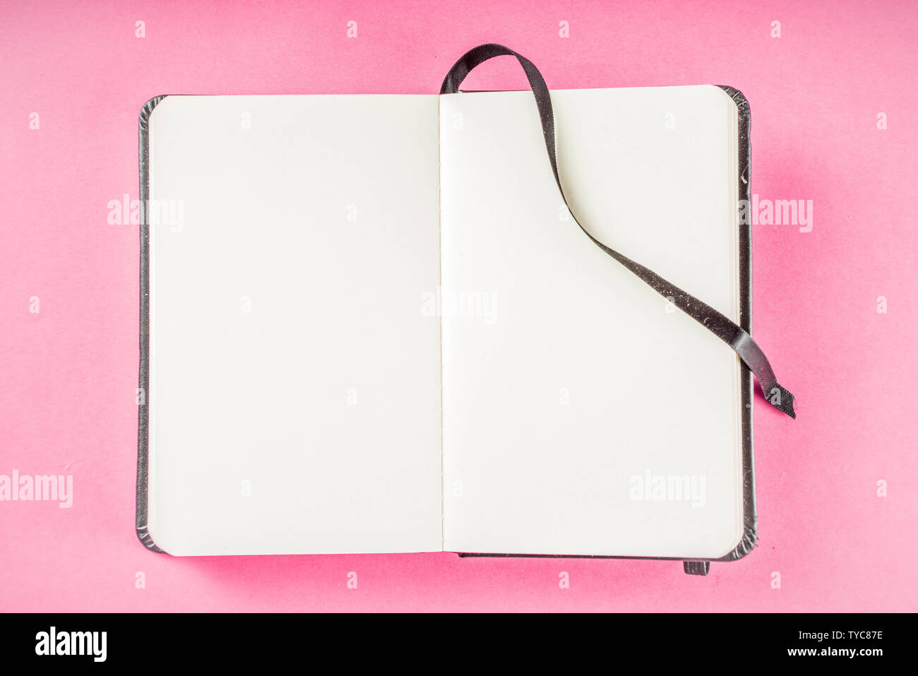 Alarm clock with notepad on bright pink table. Performance, work or study concept, Creative flatlay copy space above Stock Photo