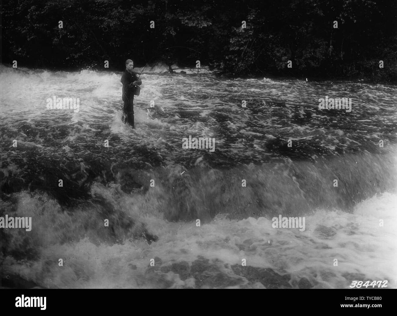 Photograph of George Encahl of Flint; Scope and content:  Original caption: George Encahl of Flint, Michigan fishing in rapids below Autrain Falls. Stock Photo