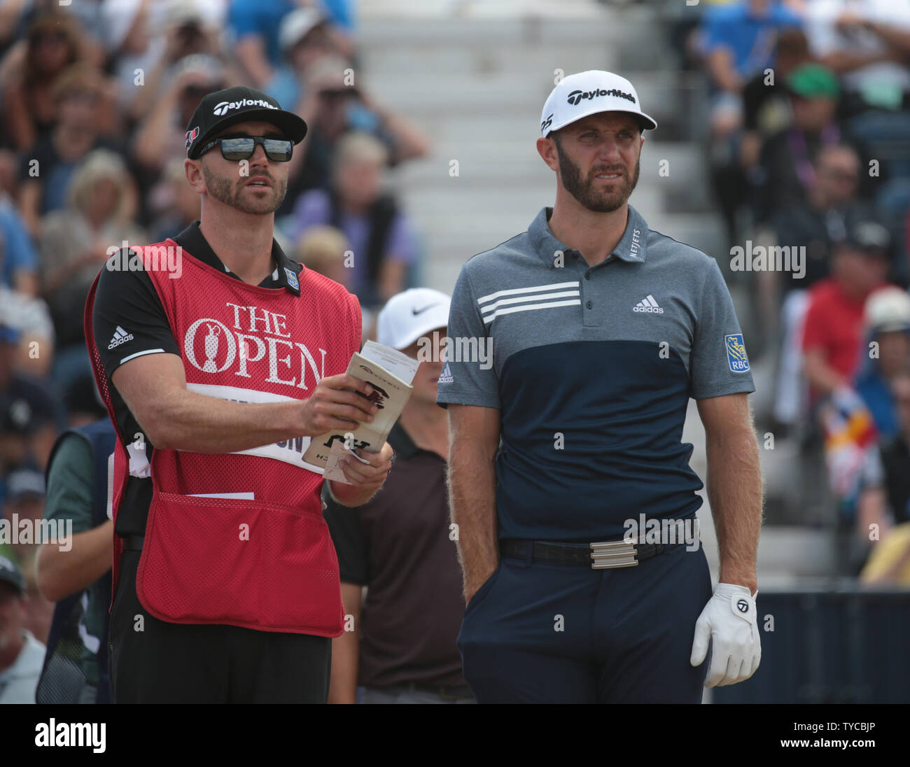 America's Dustin Johnson and his caddie on the first day of the 2018 Open Golf championships in