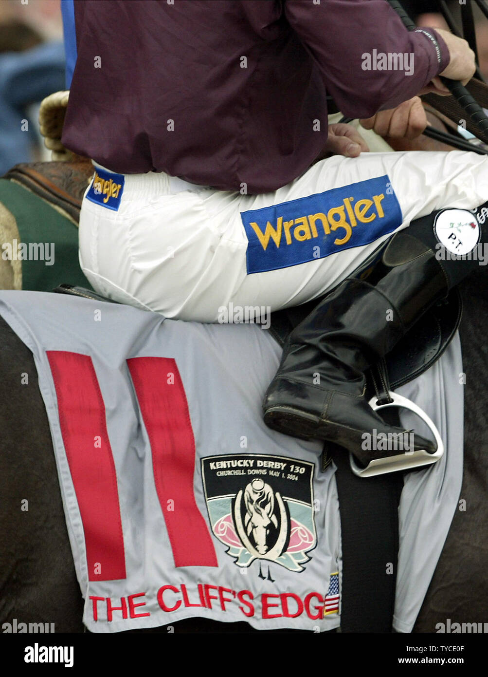 Jockey Shane Sellers, atop The Cliff's Edge, sports an advertising logo on his pants as he guides his horst to the starting gate for the 130th Kentucky Derby at Churchill Downs in Louisville, KY on May 1, 2004. Sellers was one of five jockeys to sue the Kentucky Horse Racing Authority for the right to wear advertising. (UPI Photo/Frank Polich) Stock Photo