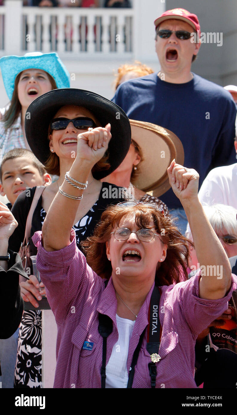 Fans in the paddock area cheer for horses running in the fifth race before the 134th running of the Kentucky Derby May 3, 2008 in Louisville, Kentucky (UPI Photo/Frank Polich) Stock Photo