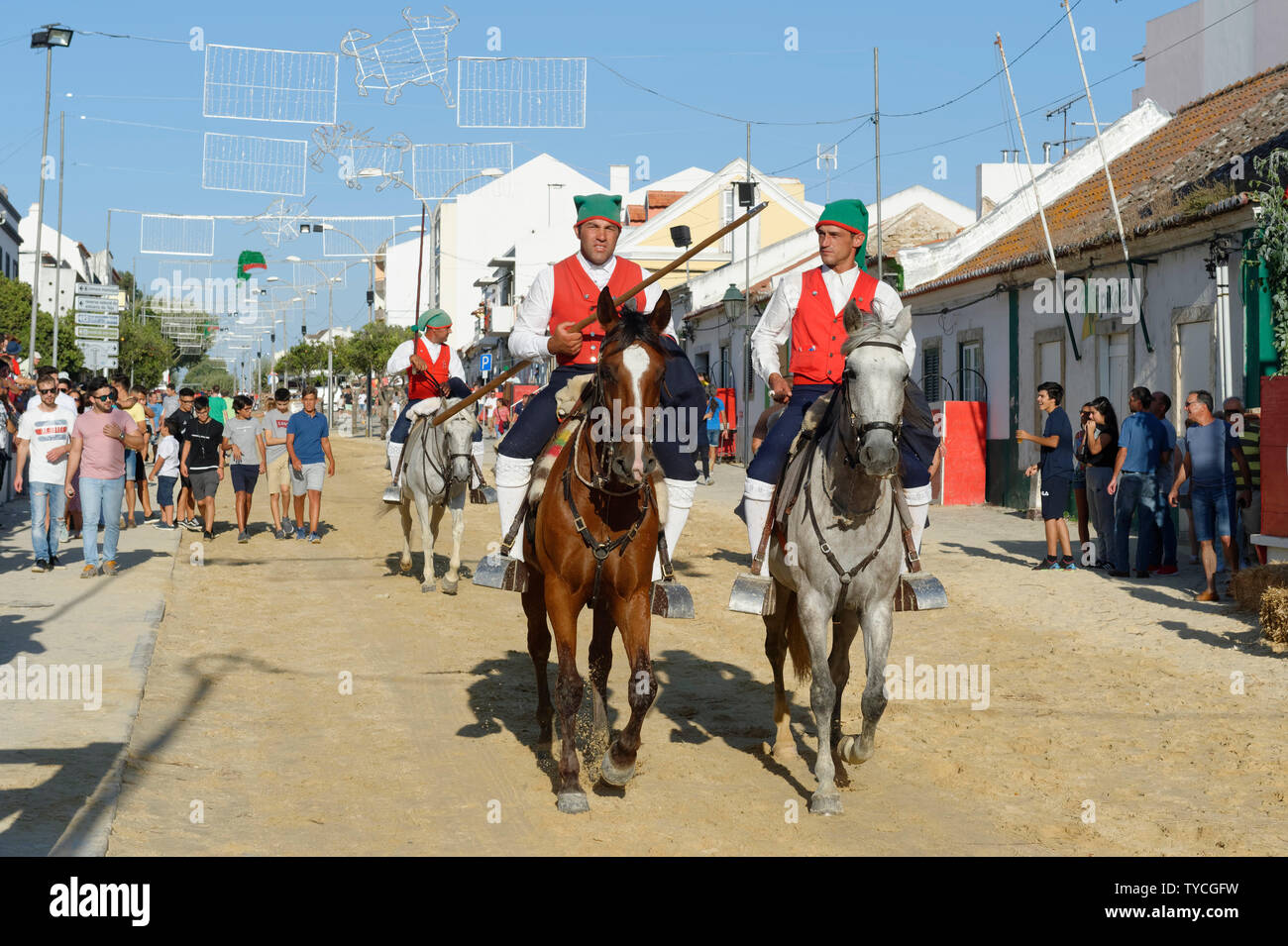 Parade of Horsemen and bulls in the streets, Festas do Barrete Verde e das Salinas, Alcochete, Setubal Province, Portugal Stock Photo