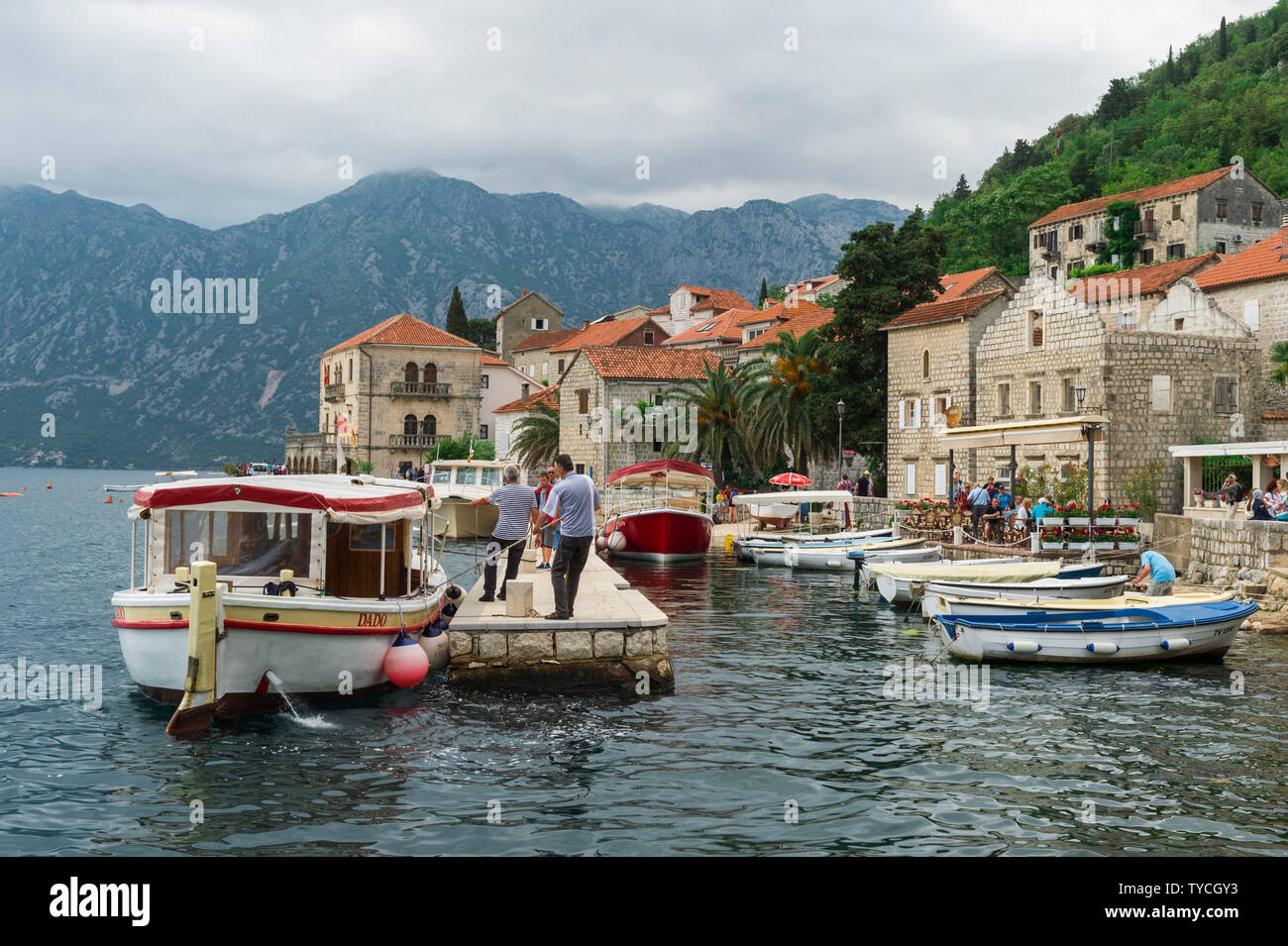 Tourist pier and Venetian Stone Houses, Kotor Bay, Perast, Montenegro Stock Photo