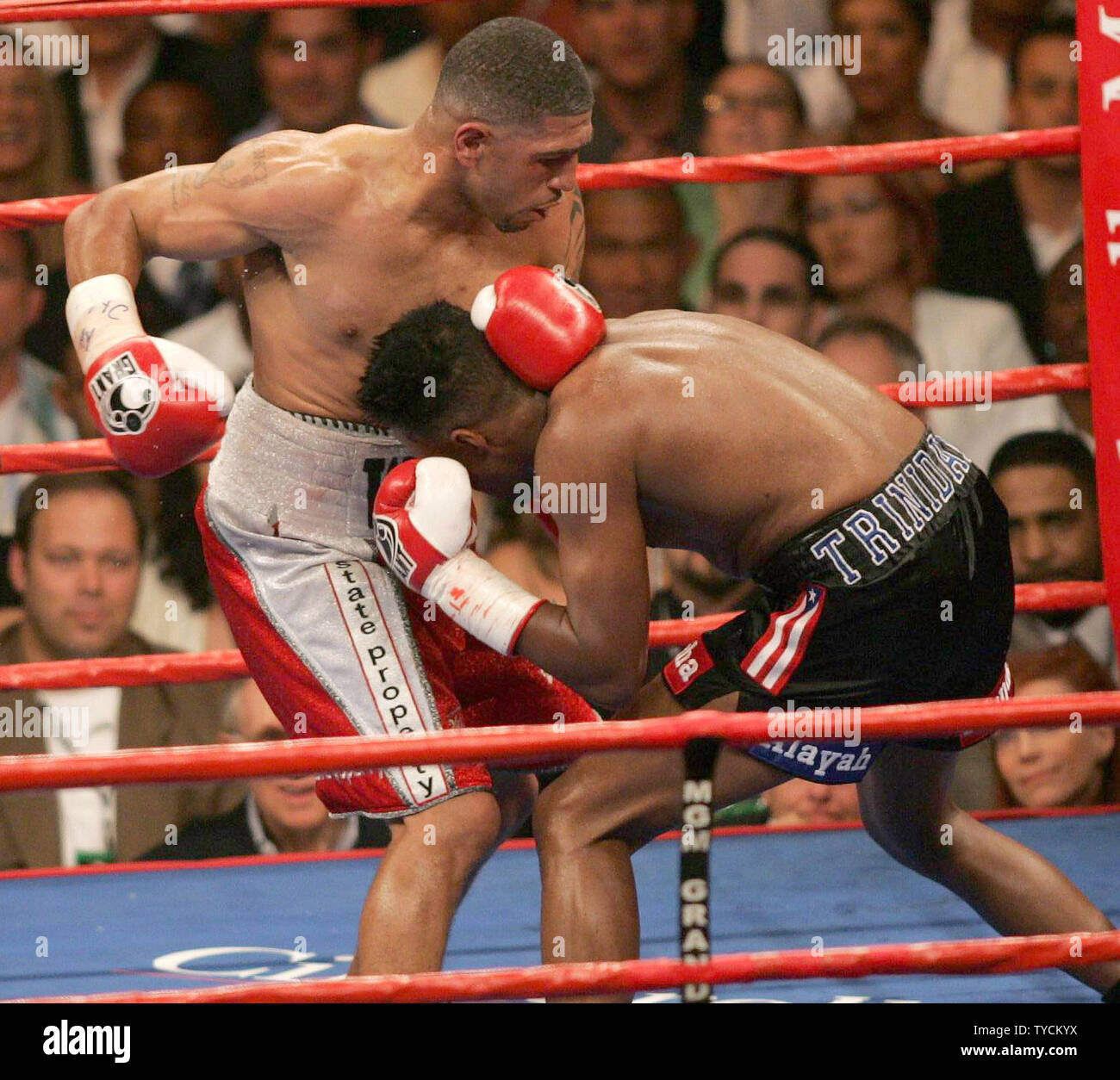 Undisputed Jr. Middleweight Champion of the World, Ronald "Winky" Wright (L) of St. Petersburg FL grapples with former multiple weight champion Tito Trinidad of Puerto Rico in a 12 round decision at MGM Grand in Las Vegas, May 14, 2005. Trinidad barely won a round in the fight.   (UPI Photo/Roger Williams) Stock Photo