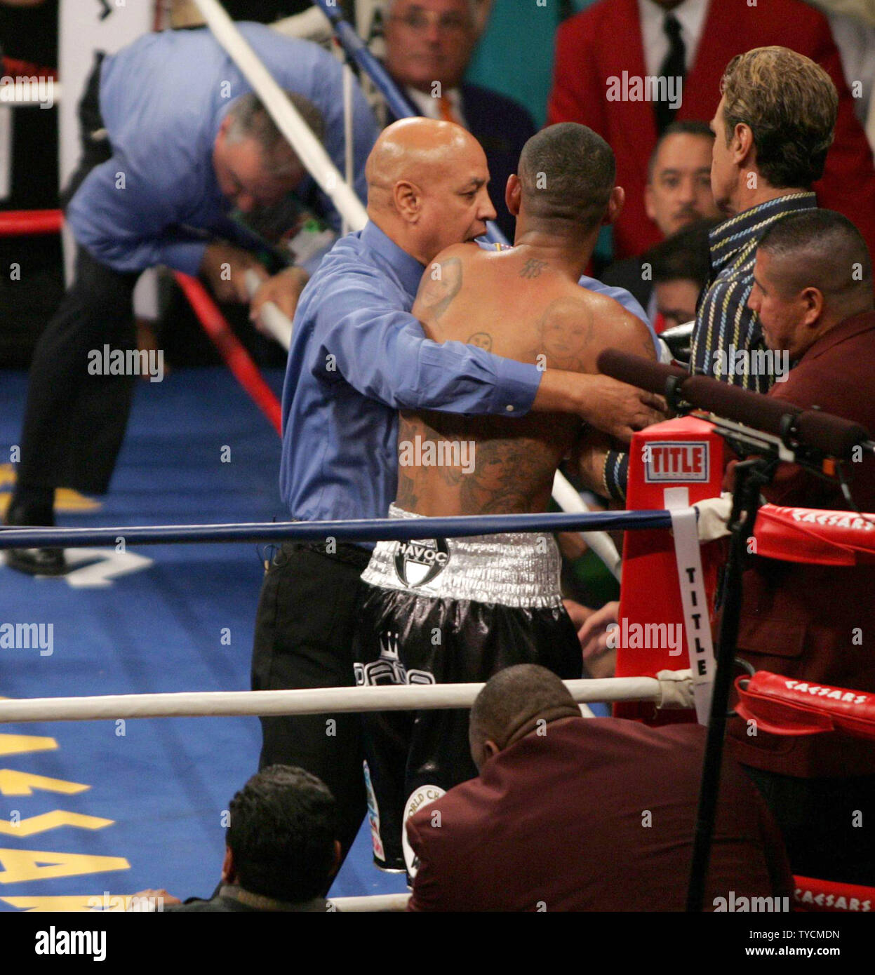 Referee Joe Cortez holds Diego Corrales of Sacramento, CA, after he was ...