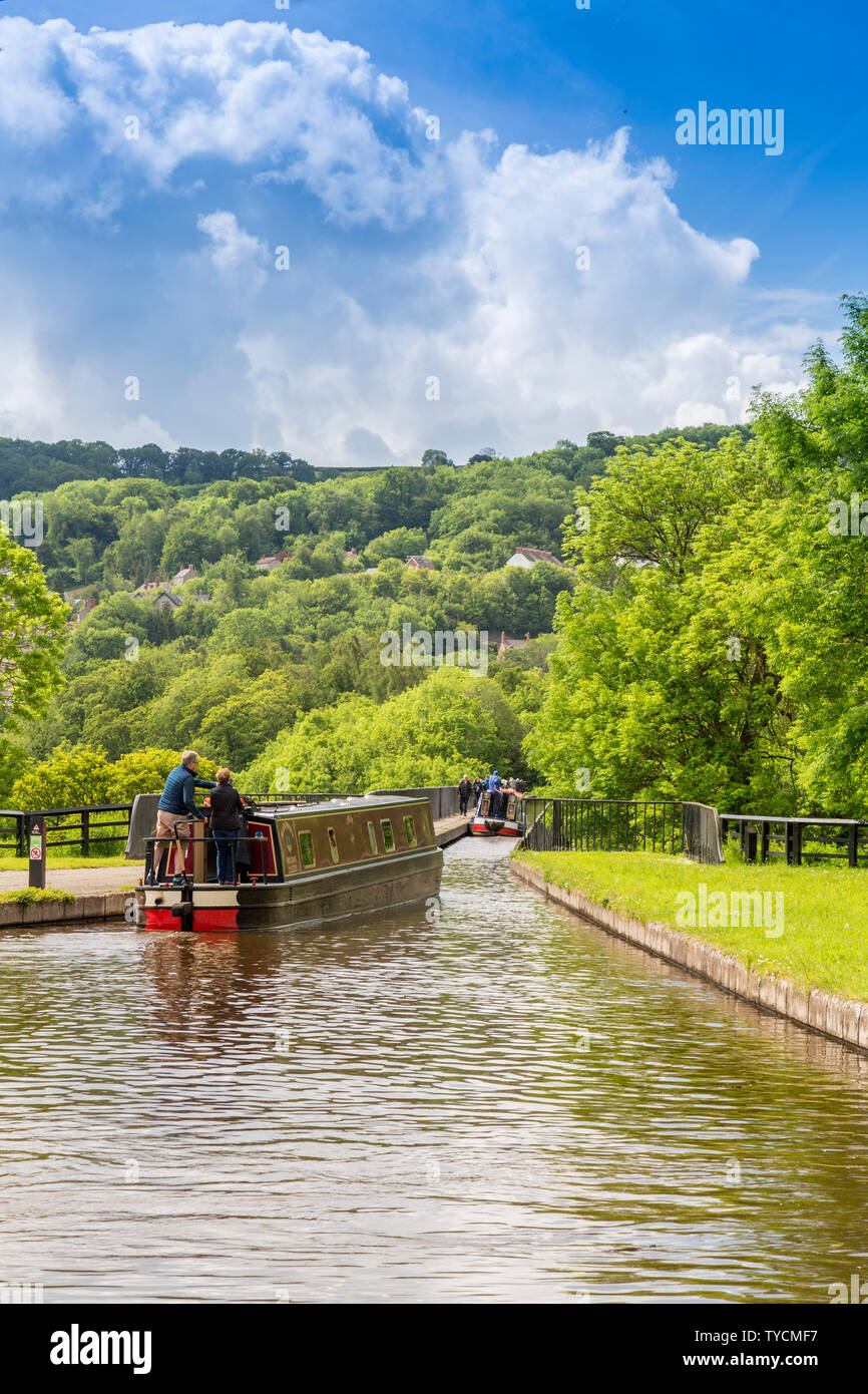 A colourful holiday narrowboat makes its way across the magnificent Pontcysyllte aqueduct on the Llangollen Canal, Clwyd, Wales, UK Stock Photo