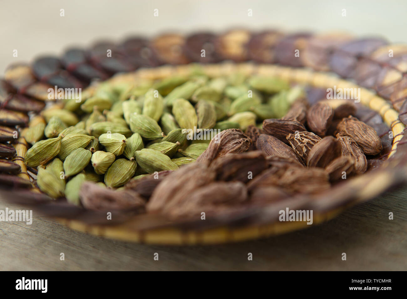 Close up of black and green cardamom in a basket Stock Photo