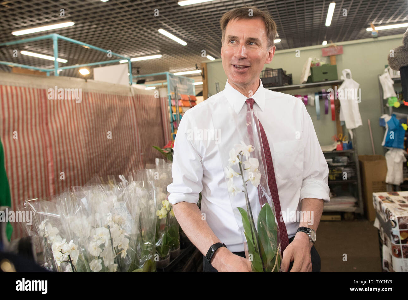 Conservative party leadership candidate Jeremy Hunt hold an orchid he bought for his wife in Chelmsford Indoor Retail Market during a visit to Chelsmford in Essex. Stock Photo