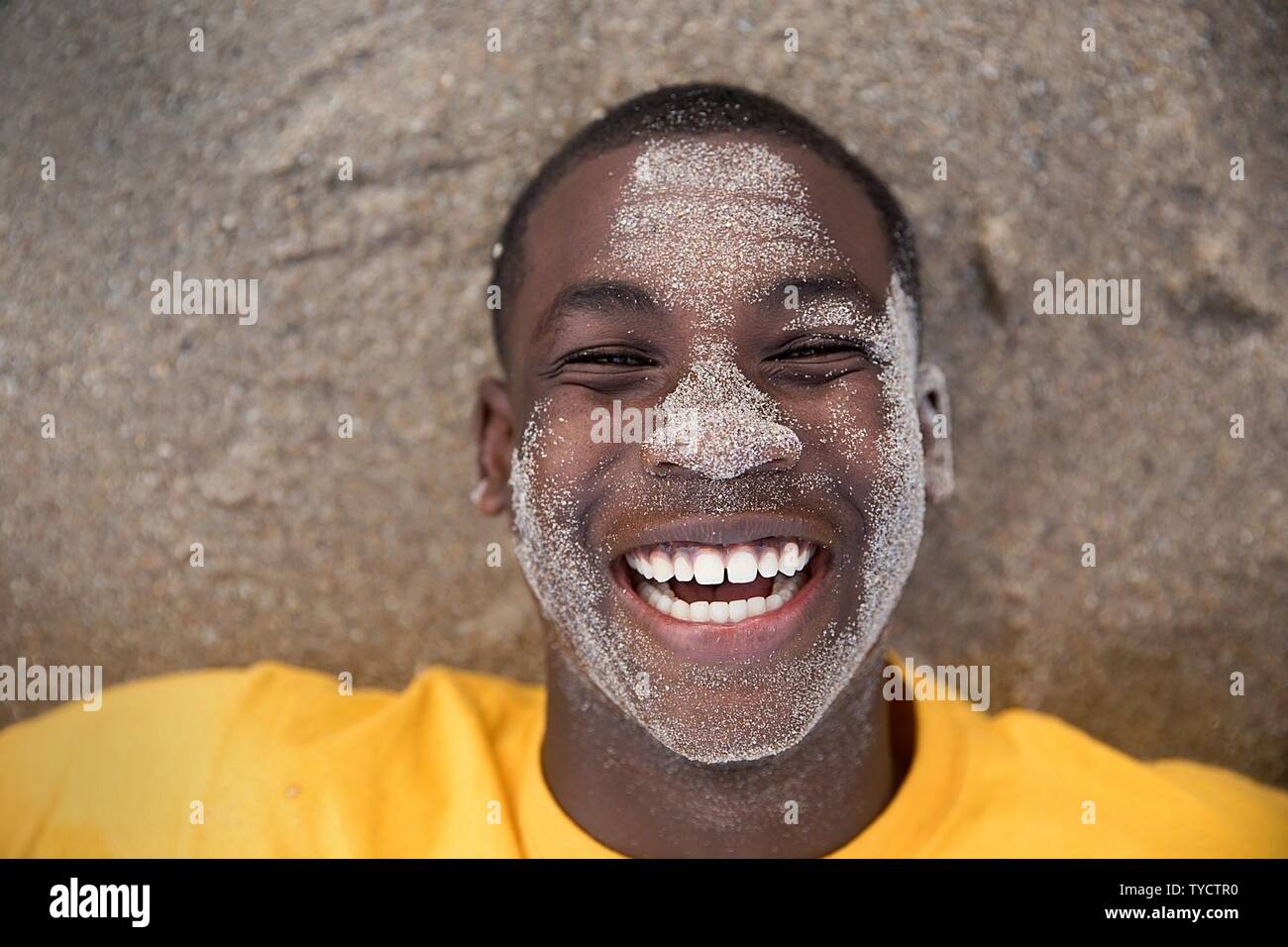 FORT PIERCE, Fla. (Nov. 5, 2016) U.S. Naval Sea Cadet Corps Seaman Apprentice Wilson, Palm Beach Division, braces himself against the surf of the Atlantic Ocean that is about to wash over him during beach physical training. Training events like these are designed to familiarize cadets with Navy life and Navy-style discipline, advanced training focuses on military and general career fields and opportunities. Stock Photo