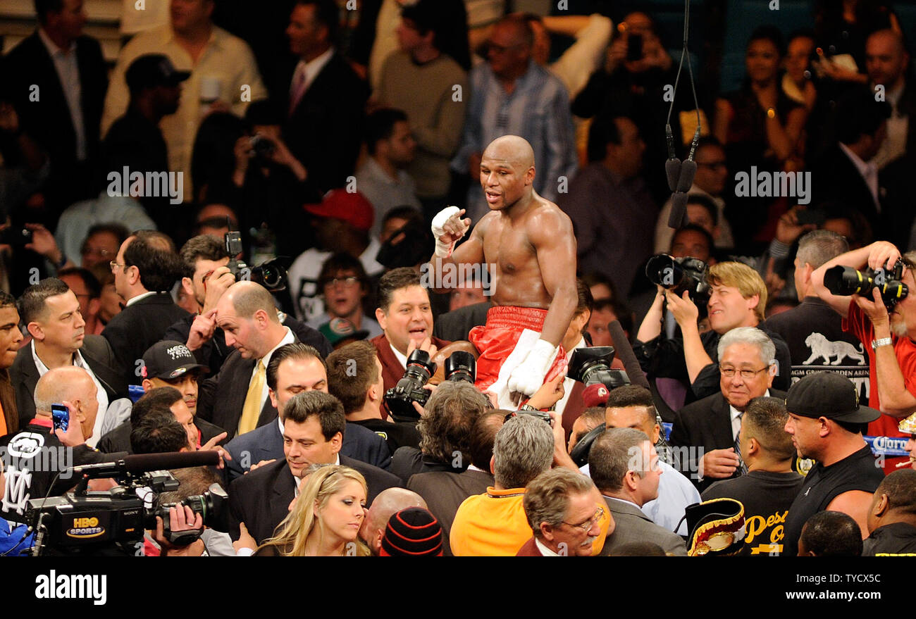 Floyd Mayweather Jr. celebrates after defeating Miguel Cotto by unanimous decision during their WBA super welterweight title fight at the MGM Grand Garden Arena in Las Vegas, Nevada on May 5, 2012.   UPI/David Becker Stock Photo