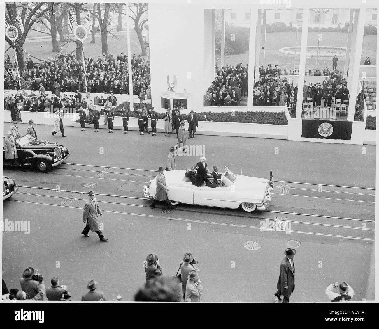 Photograph of President Dwight D. Eisenhower and First Lady Mamie Eisenhower waving to crowds as they ride in the Inaugural parade. Stock Photo