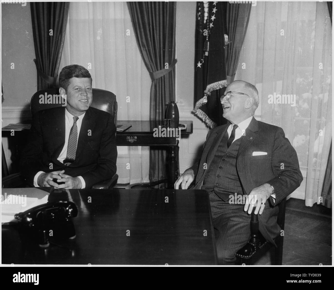 Photograph of President John F. Kennedy conferring with former President Harry S. Truman in the Oval Office, on Kennedy's first full day in the White House. Stock Photo