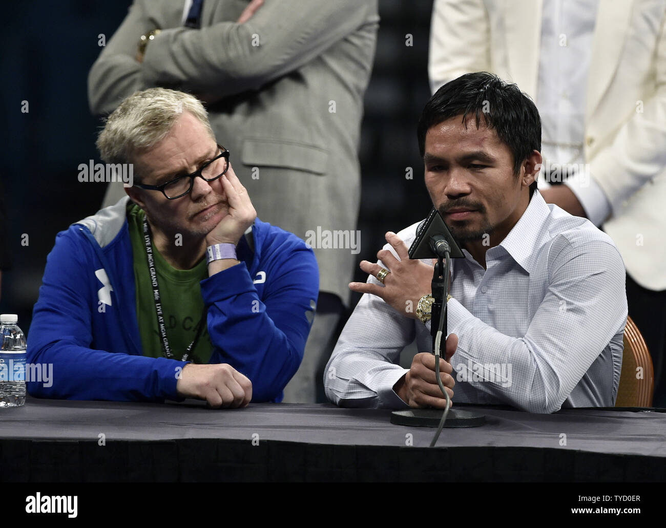 Manny Paciquiao, right, holds his shoulder as his trainer, Freddie Roach, looks on during a news conference after his welterweight unification bout against Floyd Mayweather Jr. at MGM Grand Garden Arena Saturday, May 2, 2015, in Las Vegas, Nevada. Mayweather won with an unanimous decision after the 12 round fight. Photo by David Becker/UPI Stock Photo